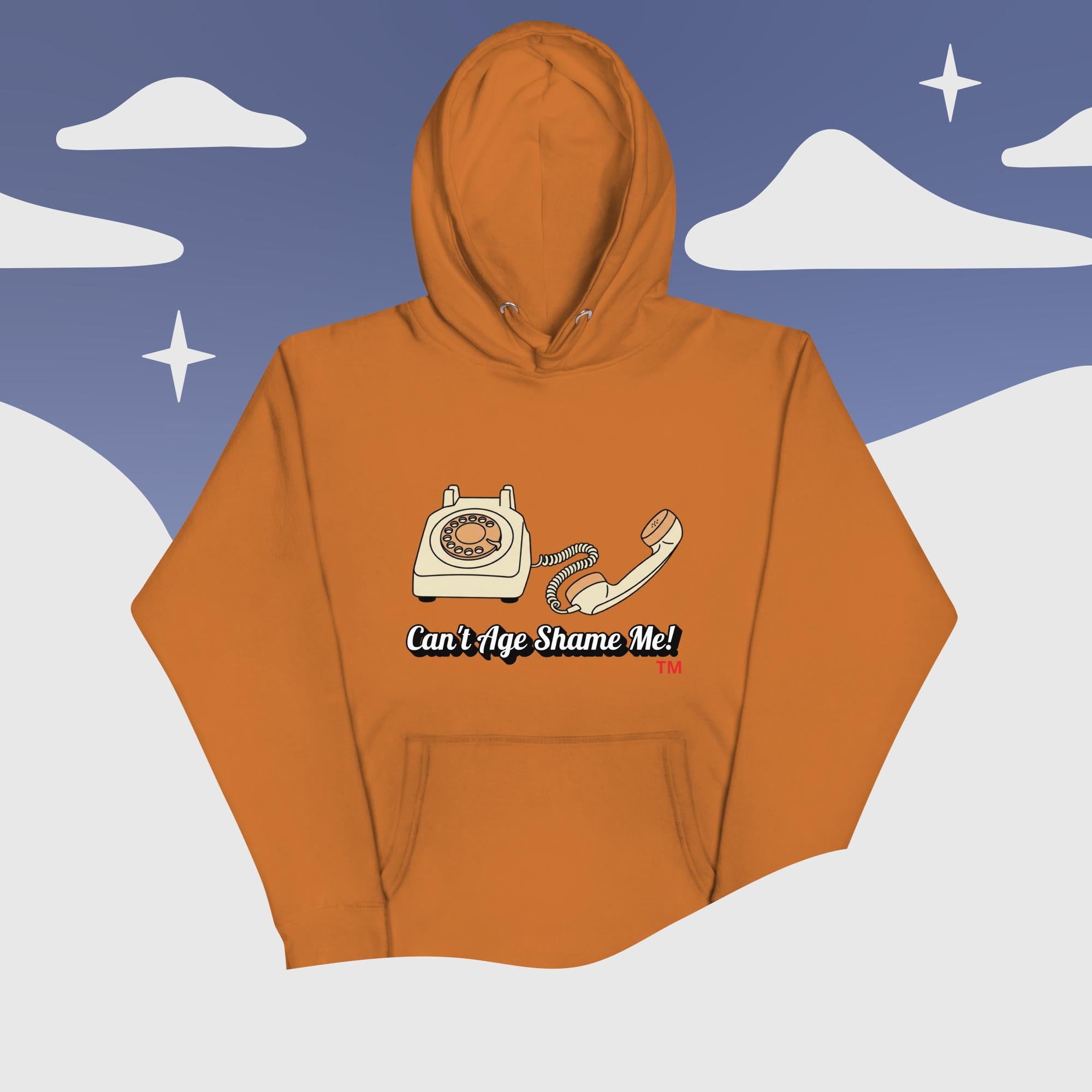 adobe  hoodie with phone graphic and text 'Can't Age Shame Me!' against a snowy mountain background