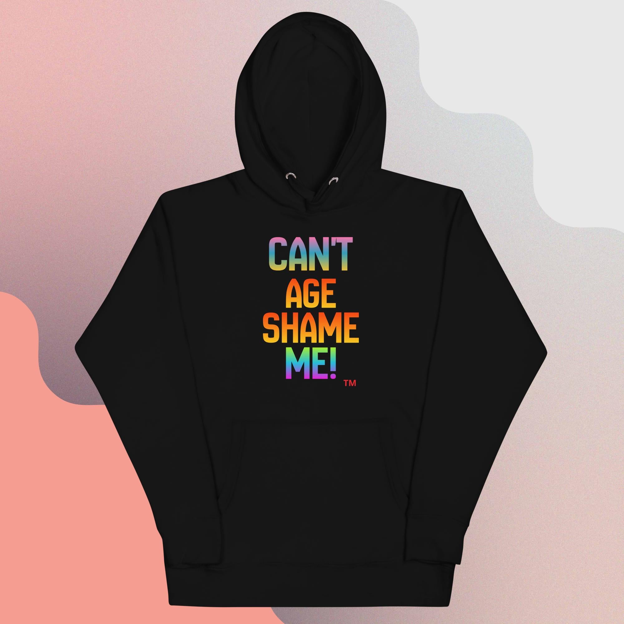 Black hoodie with colorful text 'CAN'T AGE SHAME ME!' on a gradient background
