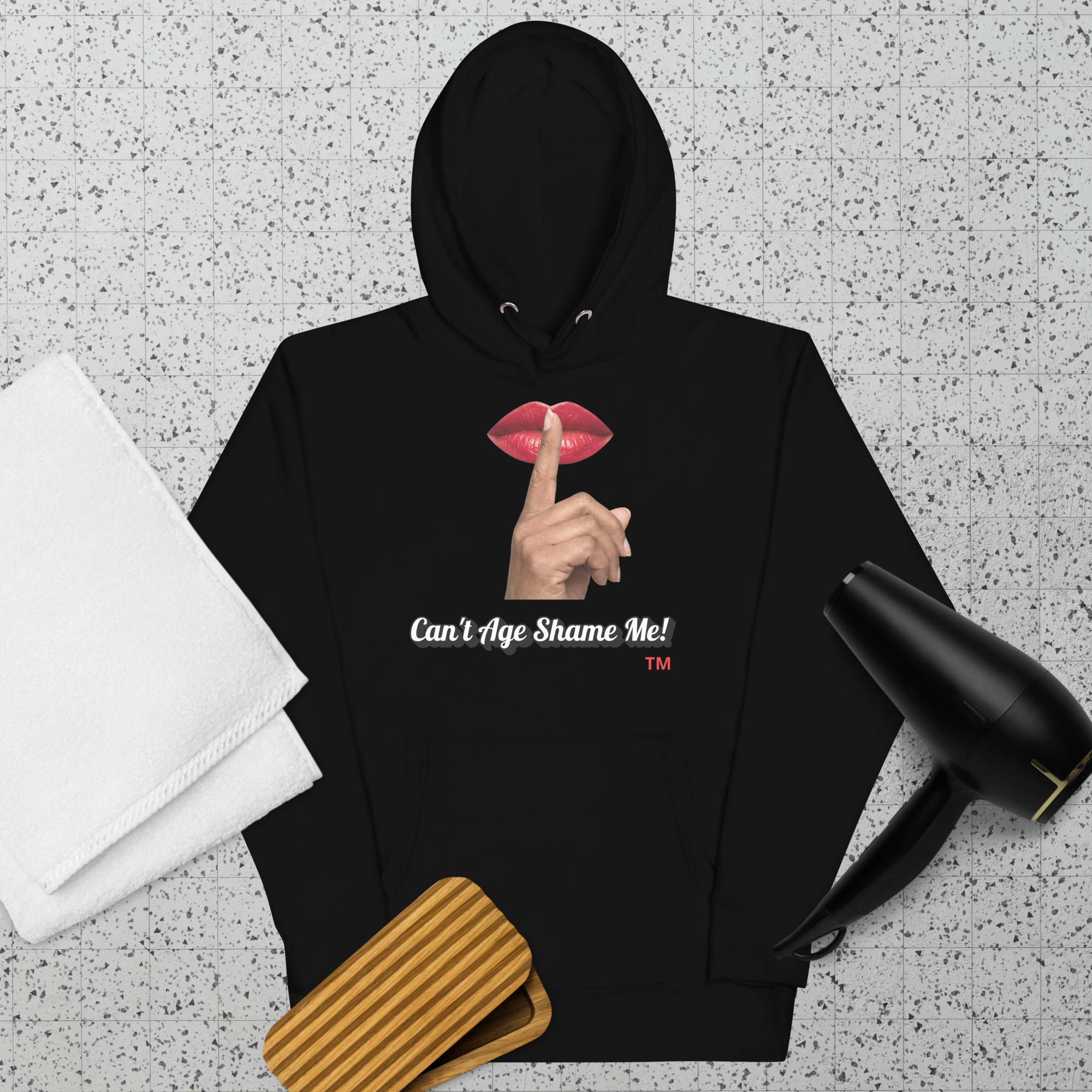 Black hoodie with a graphic design of lips and a finger on a textured surface