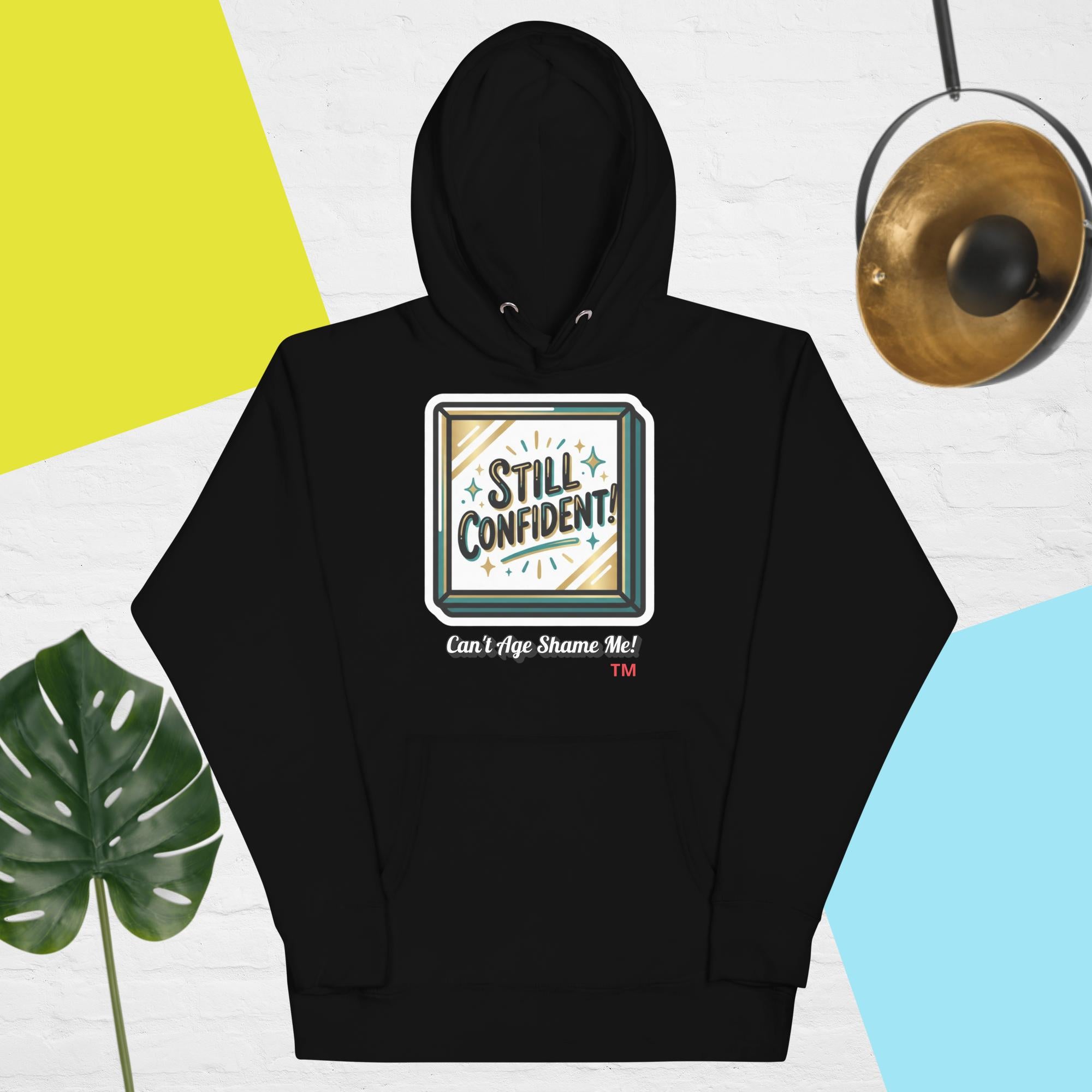 Black hoodie with 'Still Confident' graphic on a colorful background
