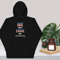 Black hoodie with colorful text design on a light gray background with a plant and jar.