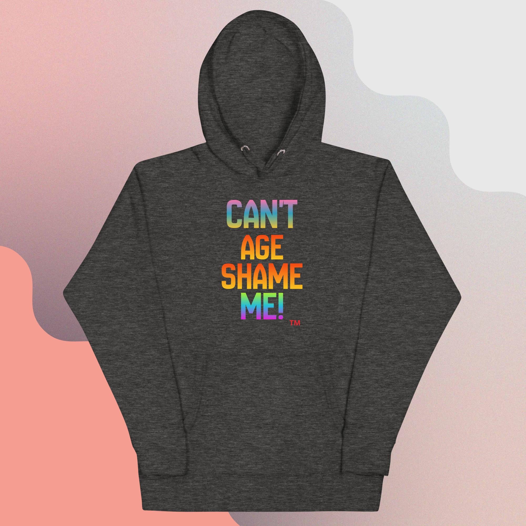 Dark gray hoodie with colorful text 'CAN'T AGE SHAME ME!' on a gradient background