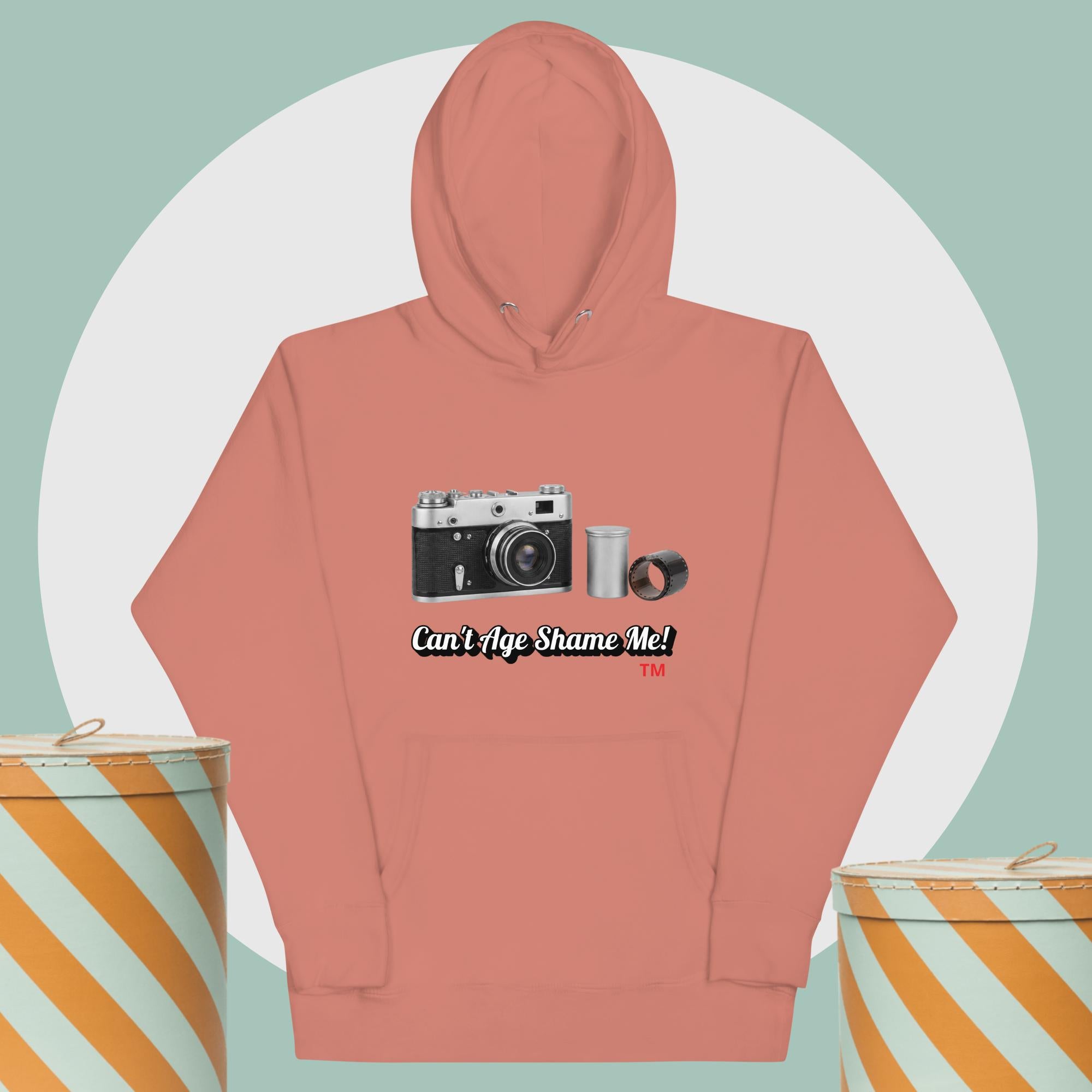 dusty rose hoodie with camera graphic background two yellow and white hat boxes