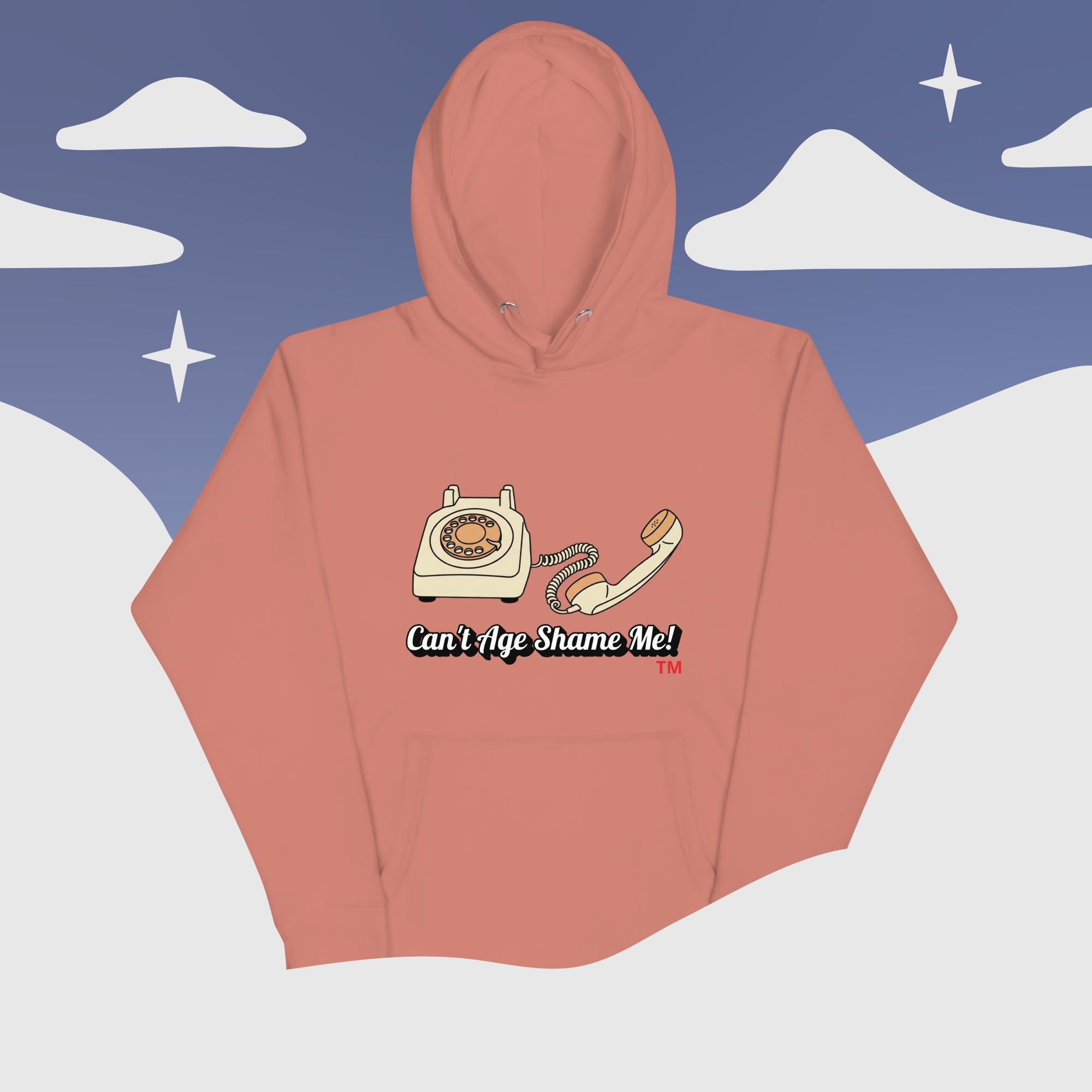 dusty rose hoodie with phone graphic and text 'Can't Age Shame Me' against a snowy mountain background