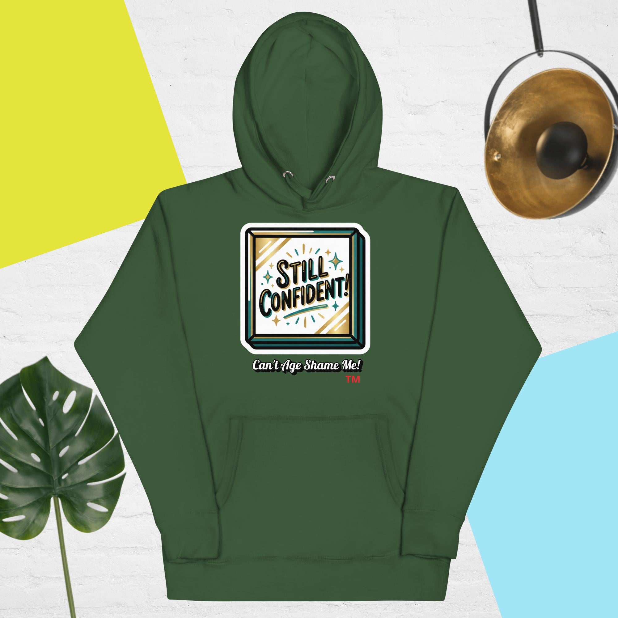 Forest Green hoodie with 'Still Confident' graphic on a colorful background