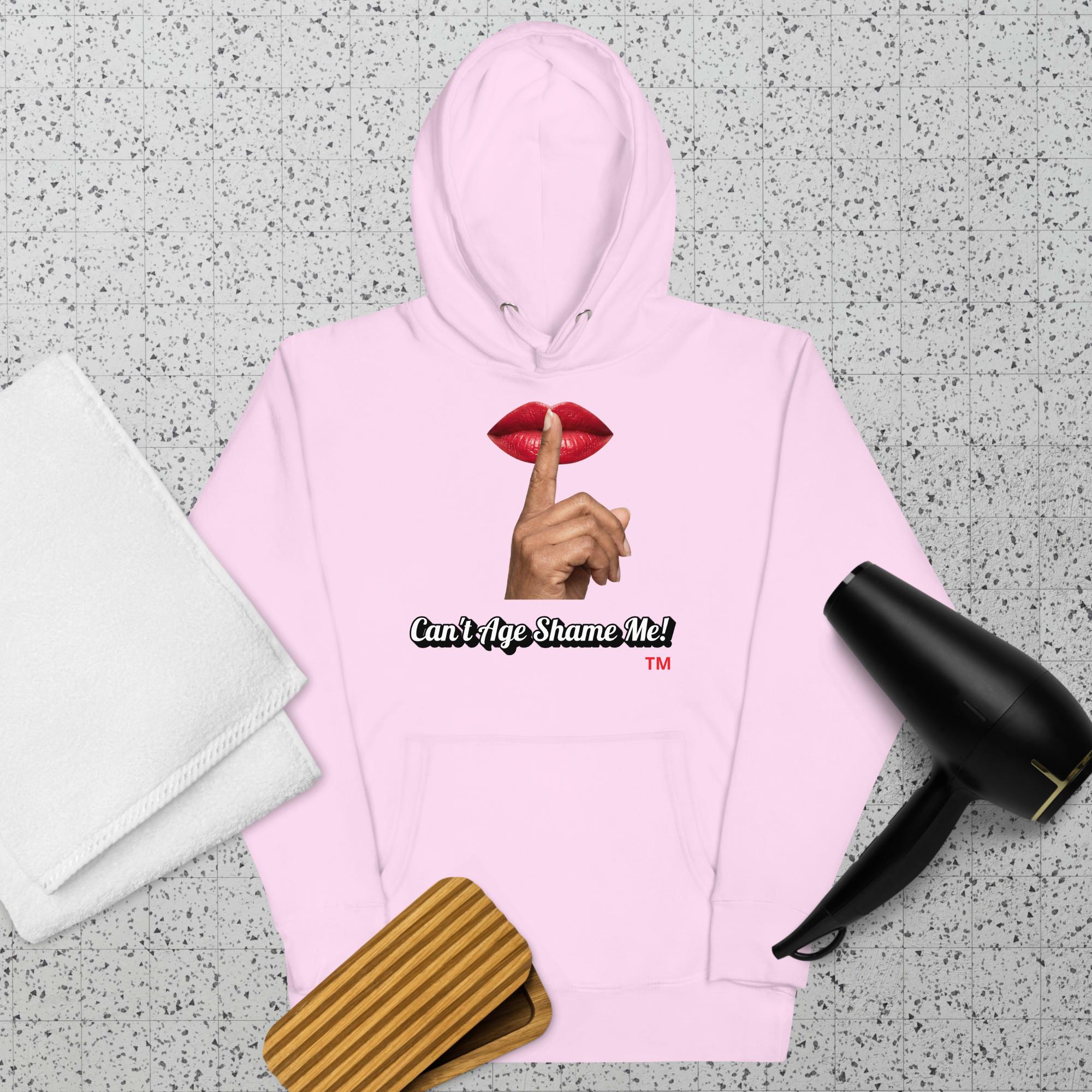 Lavendar hoodie with a graphic design of lips and a finger on a textured surface