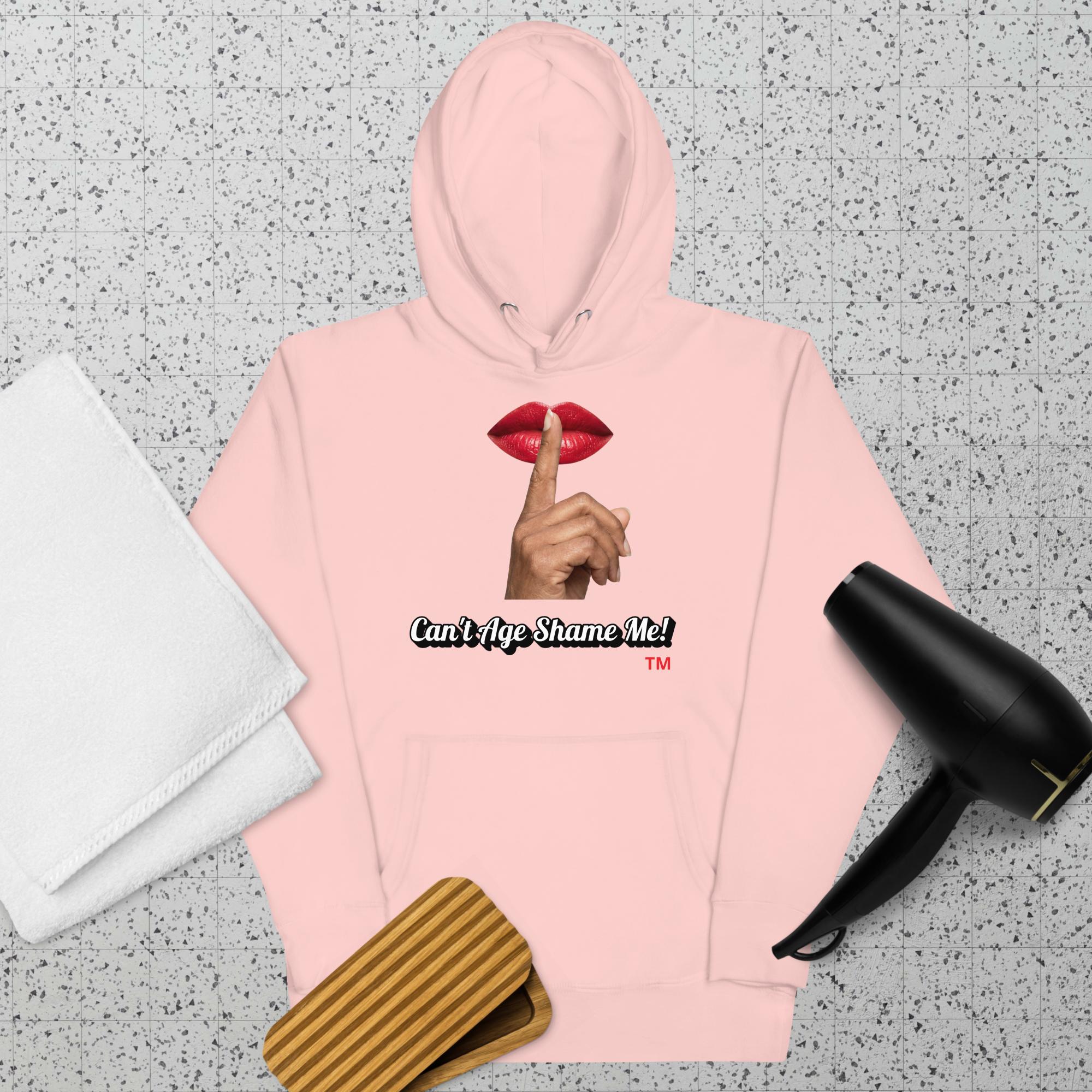 Light Pink  hoodie with a graphic design of lips and a finger on a textured surface