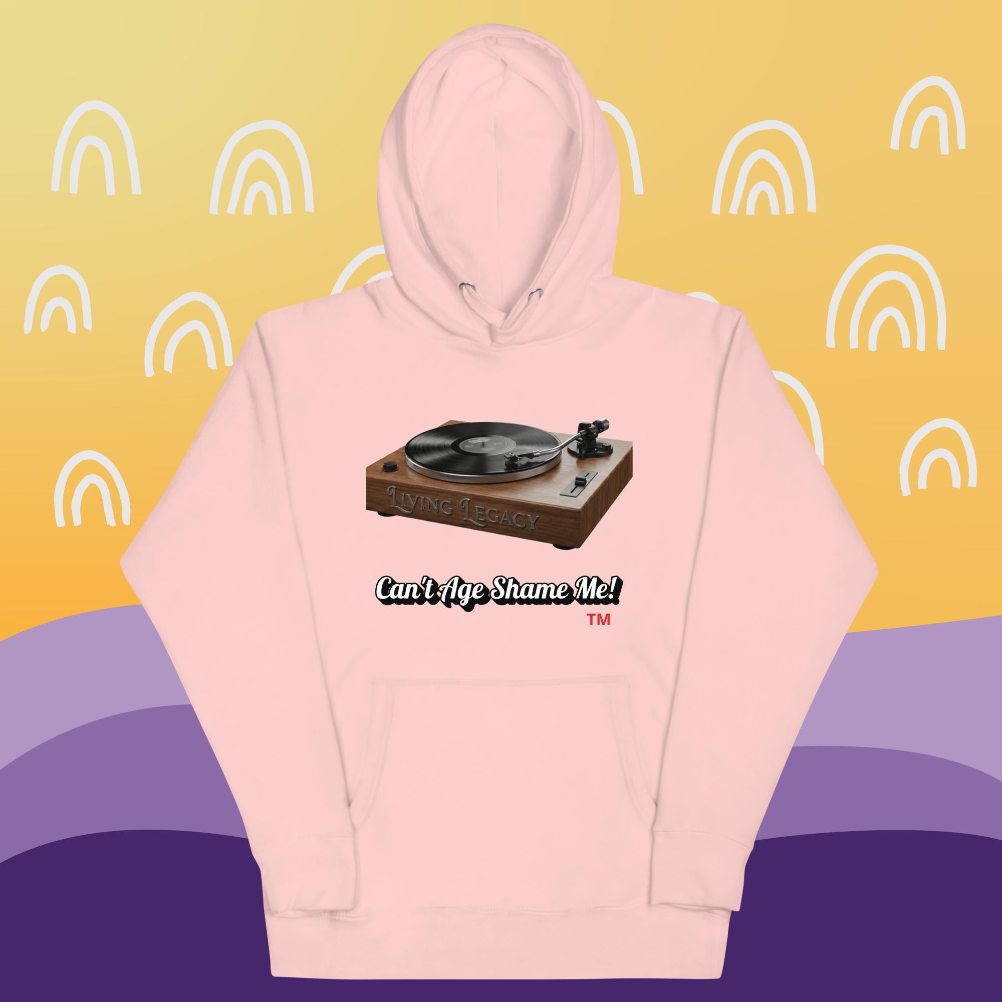 light pink hoodie with a graphic of a turntable and text can't age shame me! on a yellow and purple background