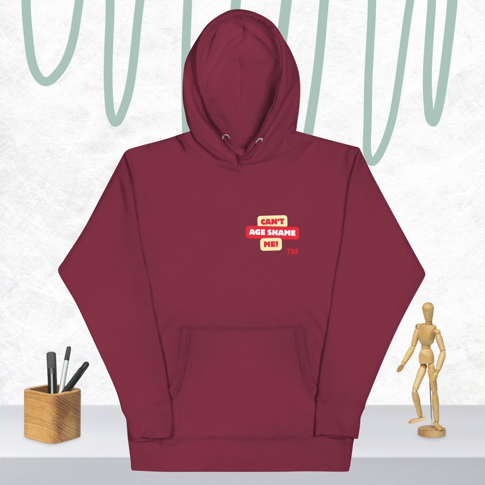 Maroon hoodie with a red and white logo text 'CAN'T AGE SHAME ME! on a light gray background