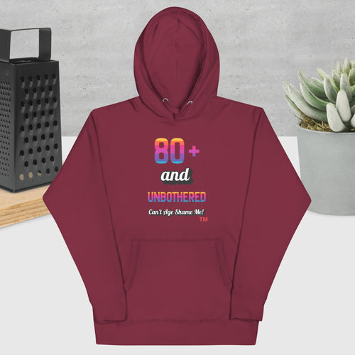 Maroon hoodie with colorful text design on a neutral background
