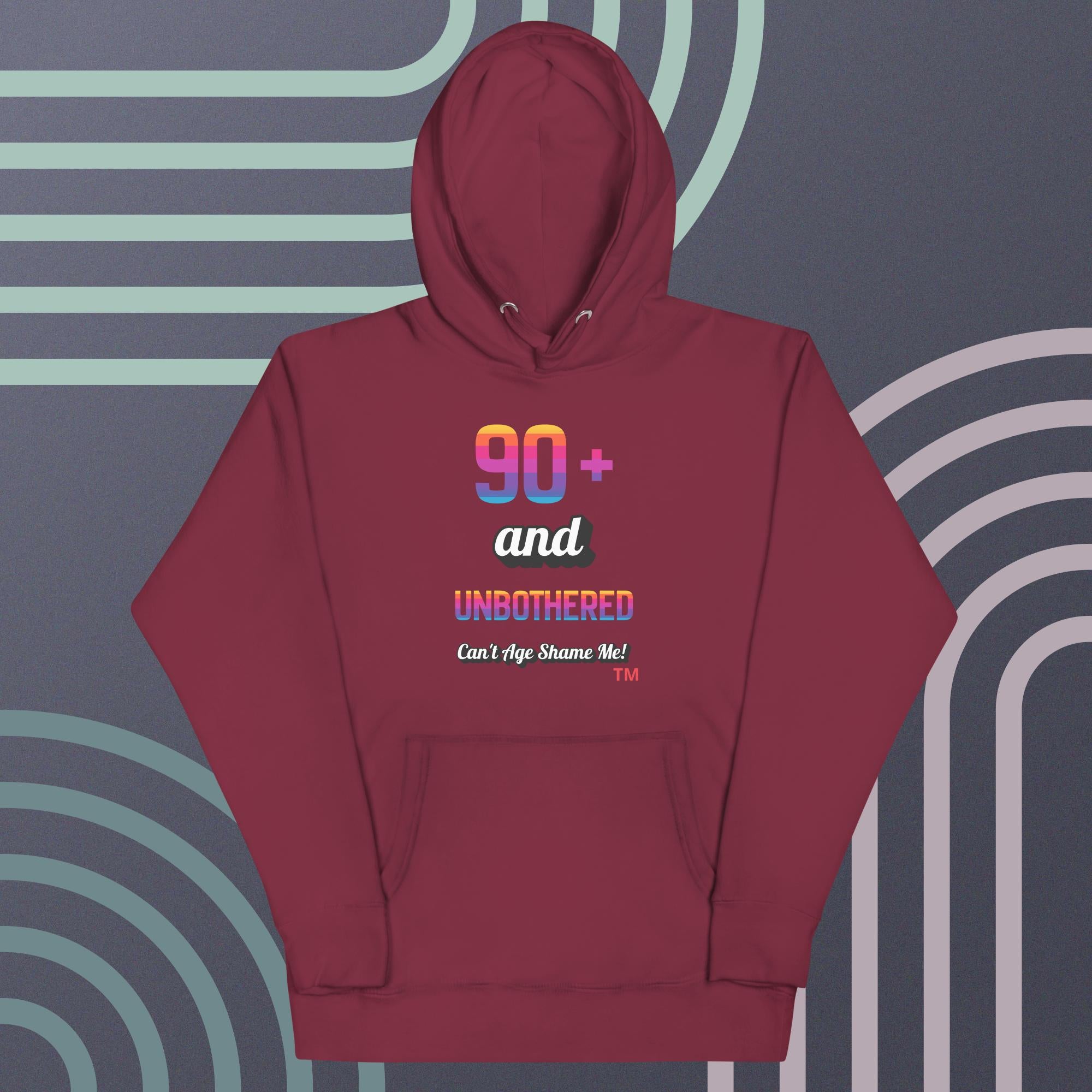 Maroon hoodie with colorful text design on a gray background