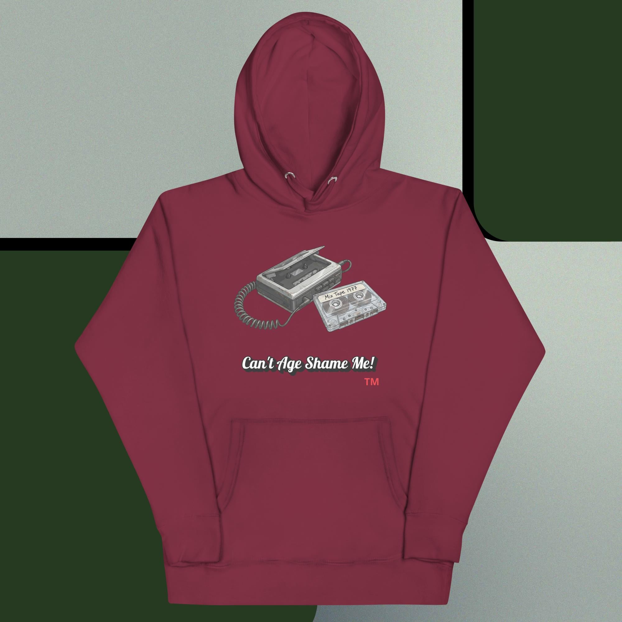 Maroon hoodie with cassette tape design and text on a gray and green background