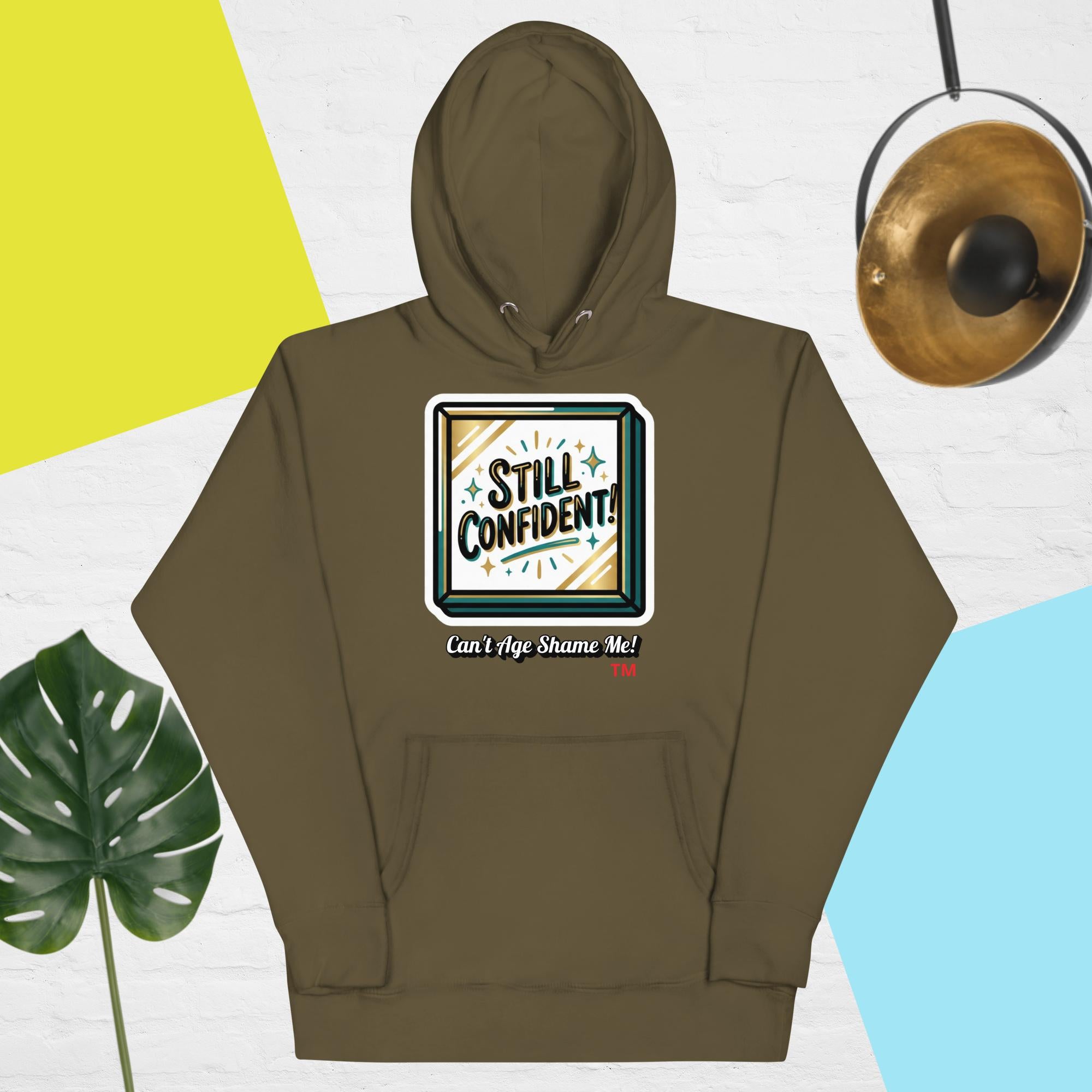 Military Green hoodie with 'Still Confident' graphic on a colorful background
