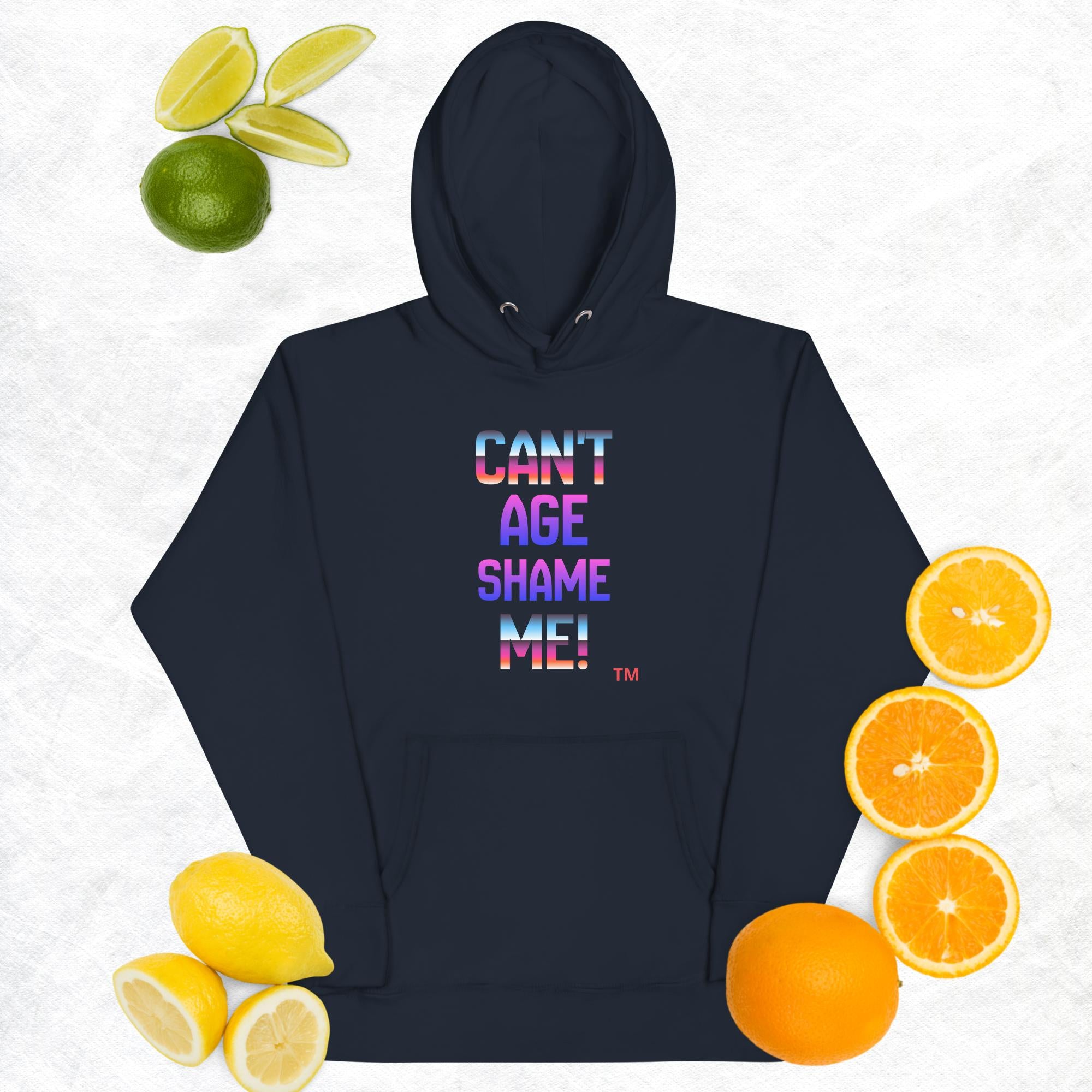 Navy hoodie with colorful text 'CAN'T AGE SHAME ME!' surrounded by citrus fruits on a white background