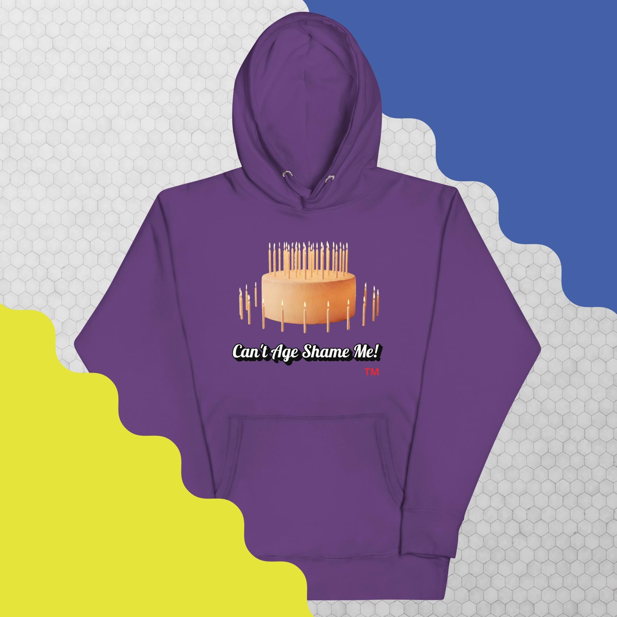 Purple hoodie with birthday cake graphic and text on a geometric patterned background