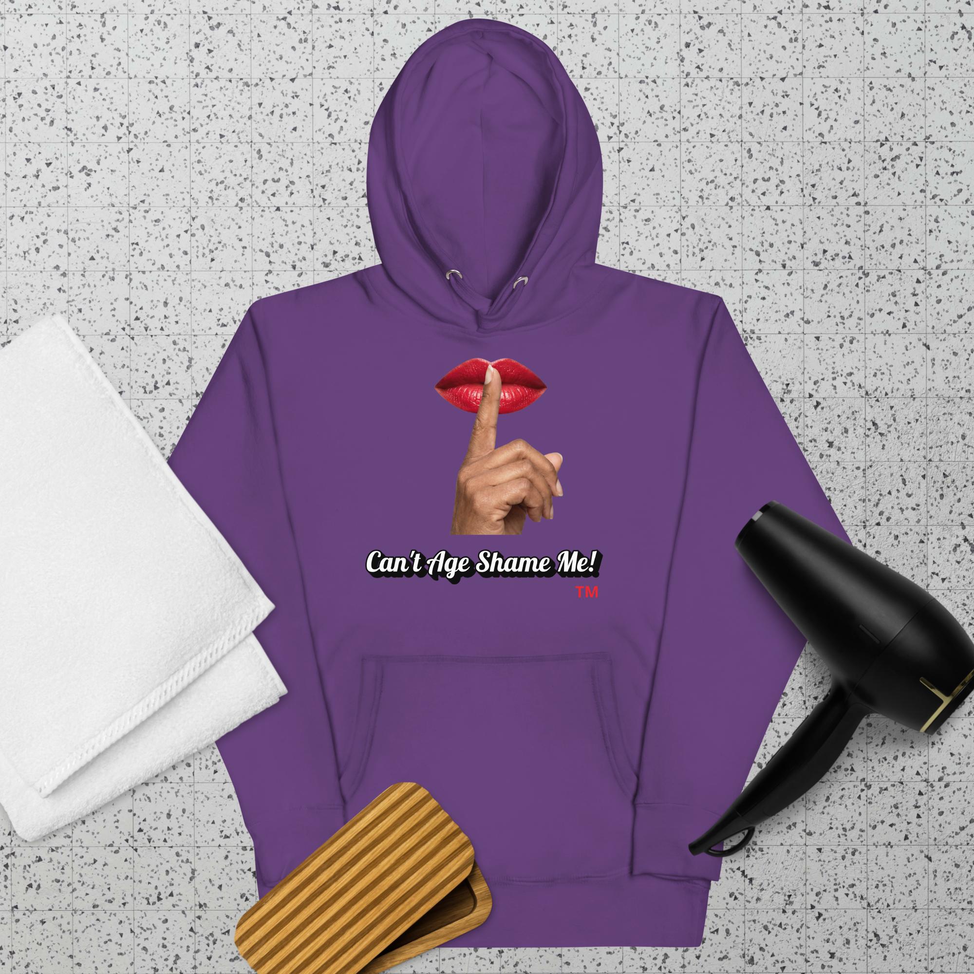 Purple hoodie with a graphic design of lips and a finger on a textured surface