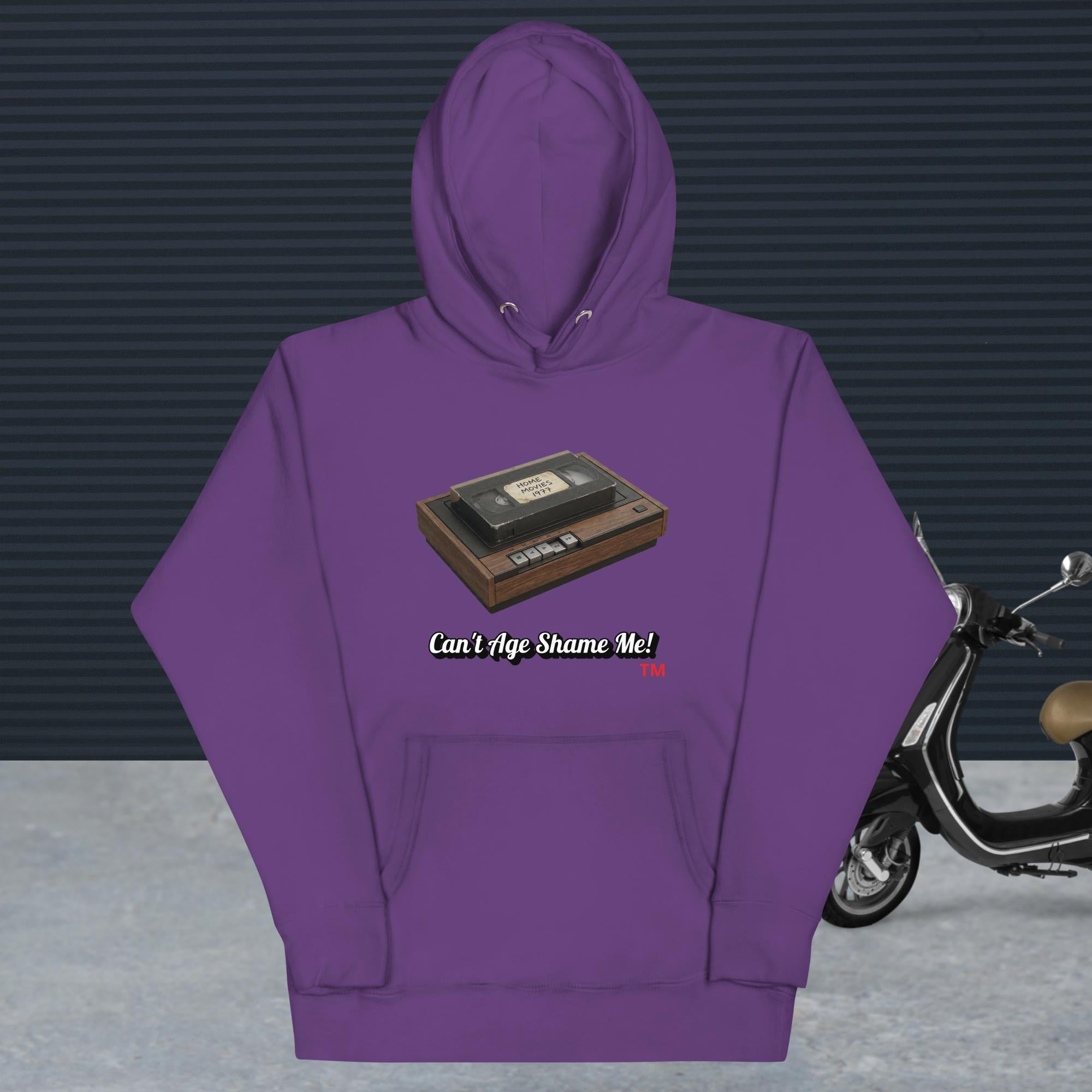 purple hoodie with a design of vhs recorder and tape