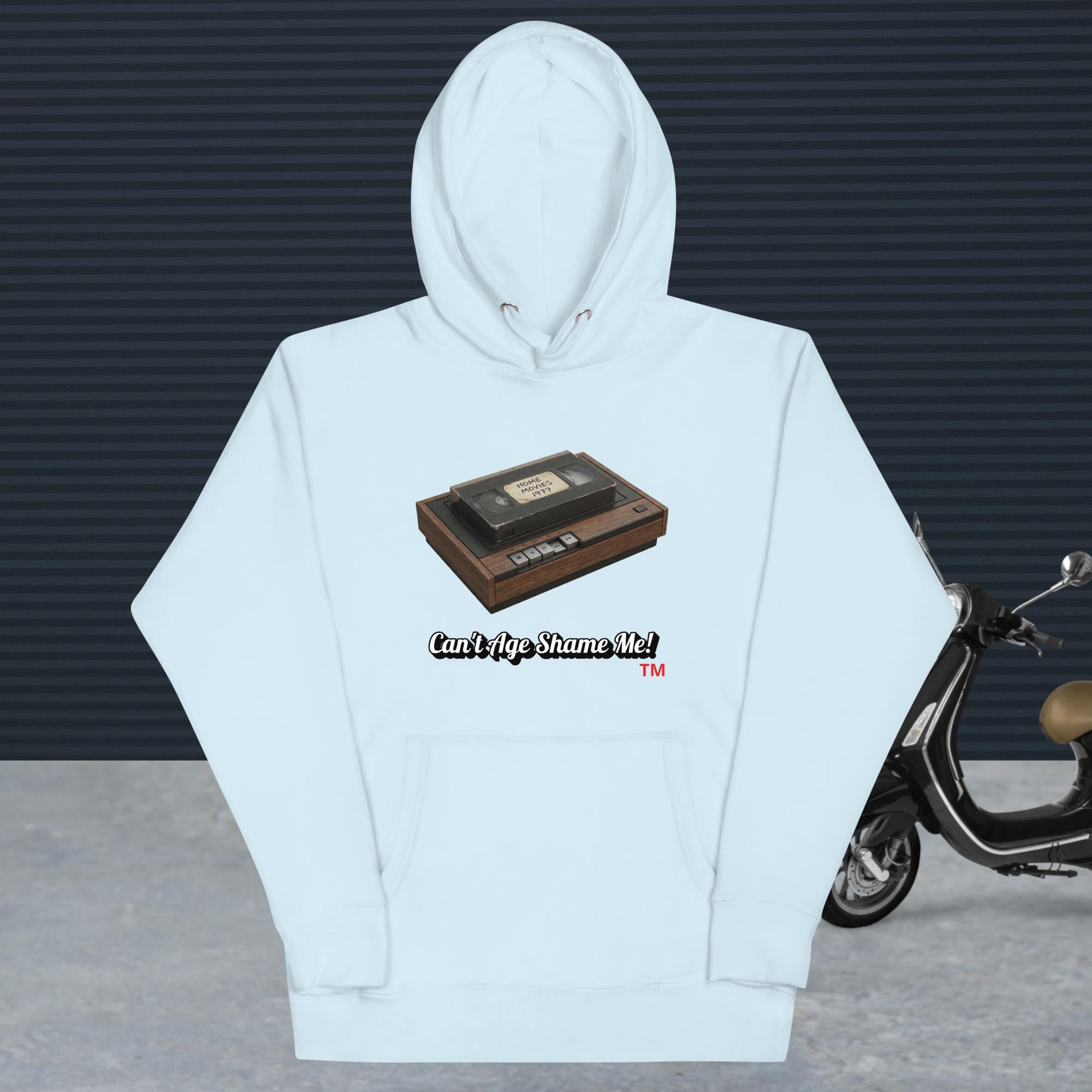 sky blue hoodie with a design of vhs recorder and tape
