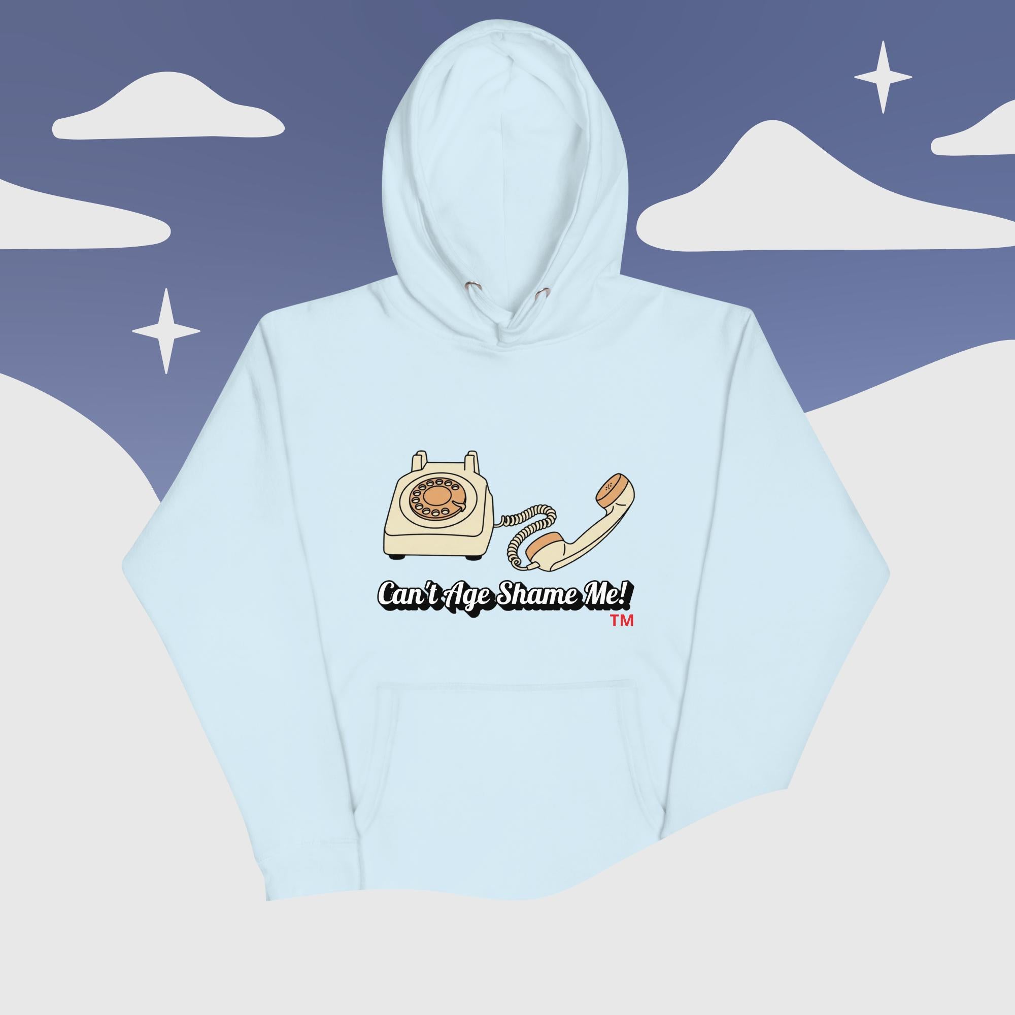 sky  blue hoodie with phone graphic and text 'Can't Age Shame Me!' on a stylized sky and cloud background.