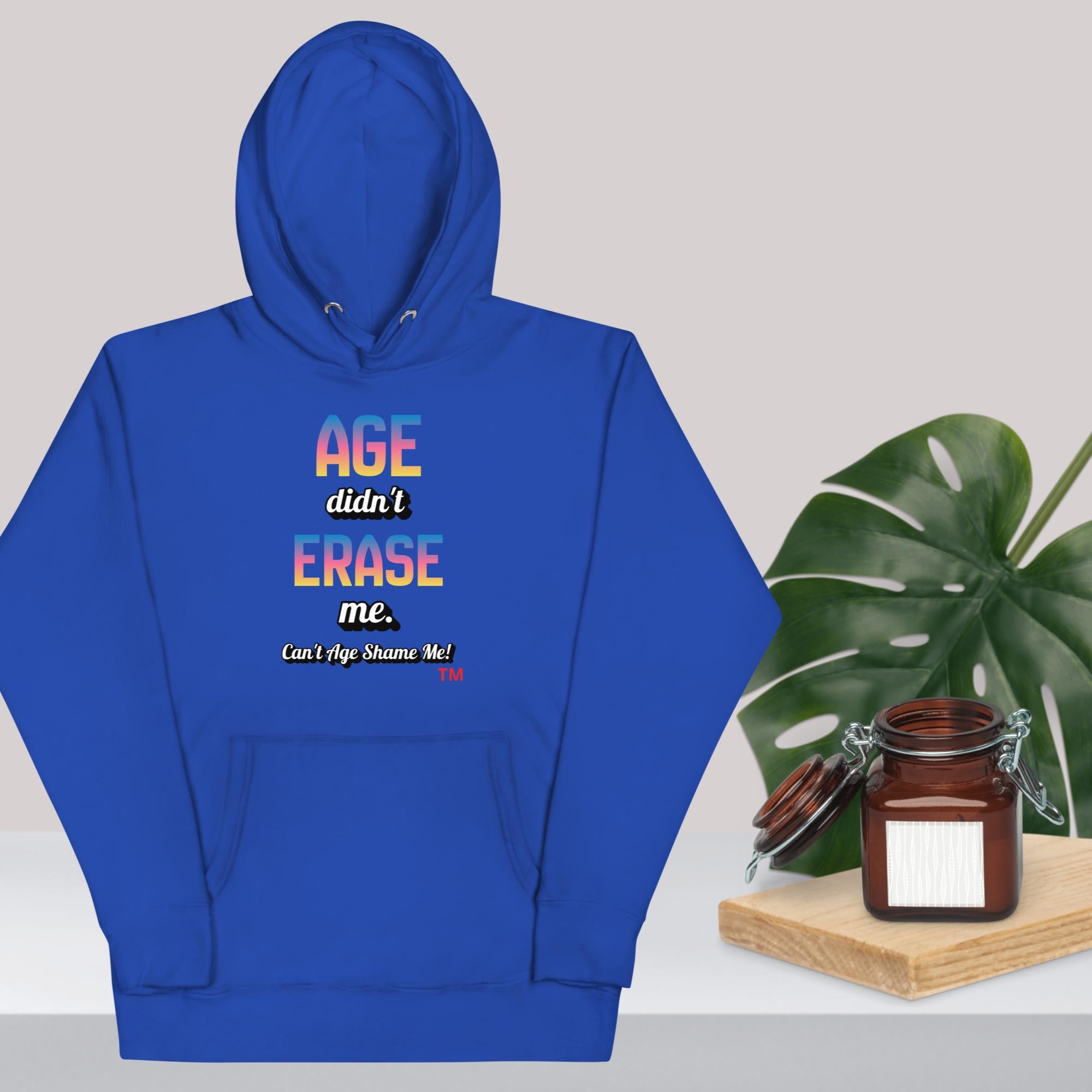 Royal Blue hoodie with colorful text design on a light gray background with a plant and jar.