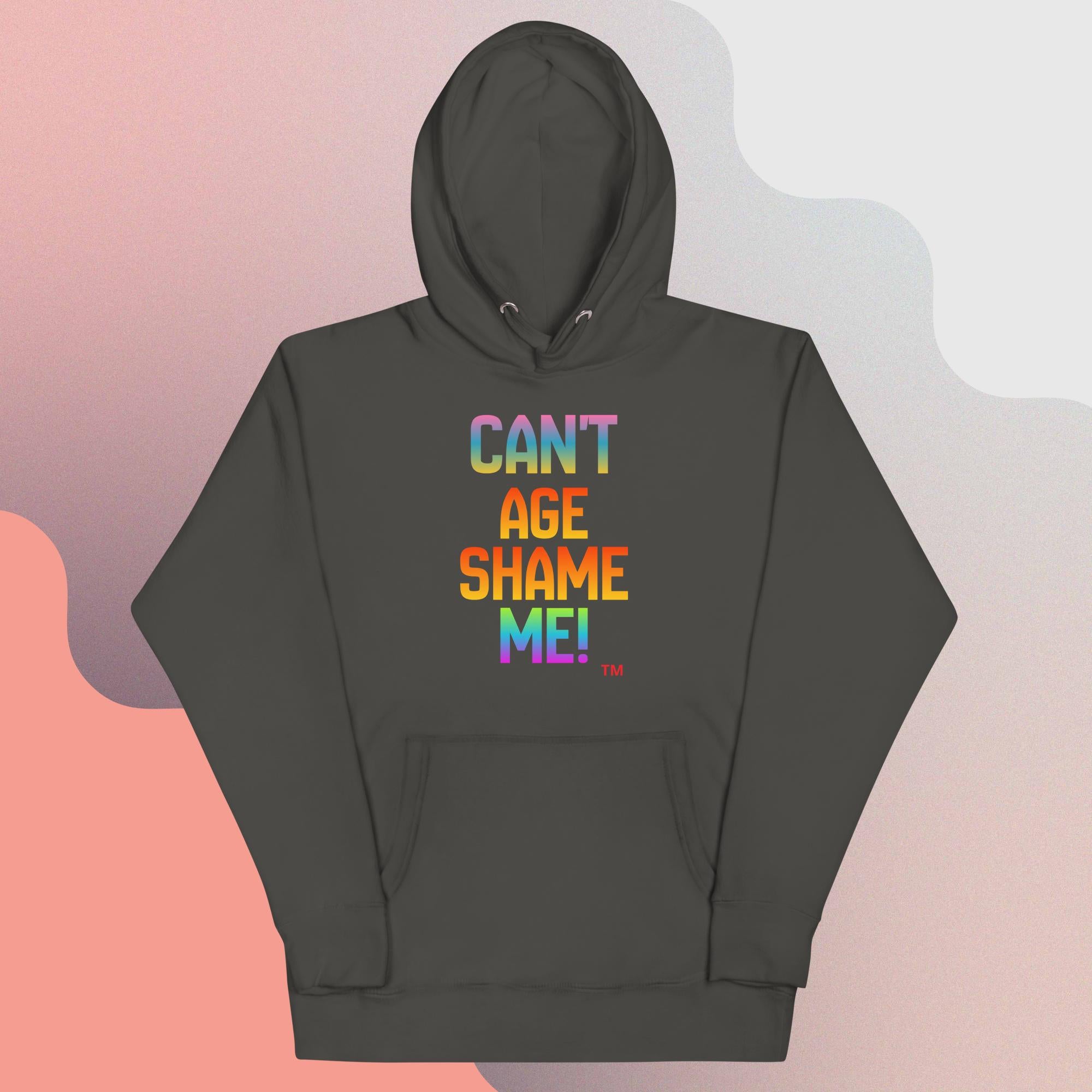 Dark gray hoodie with colorful text 'CAN'T AGE SHAME ME!' on a gradient background