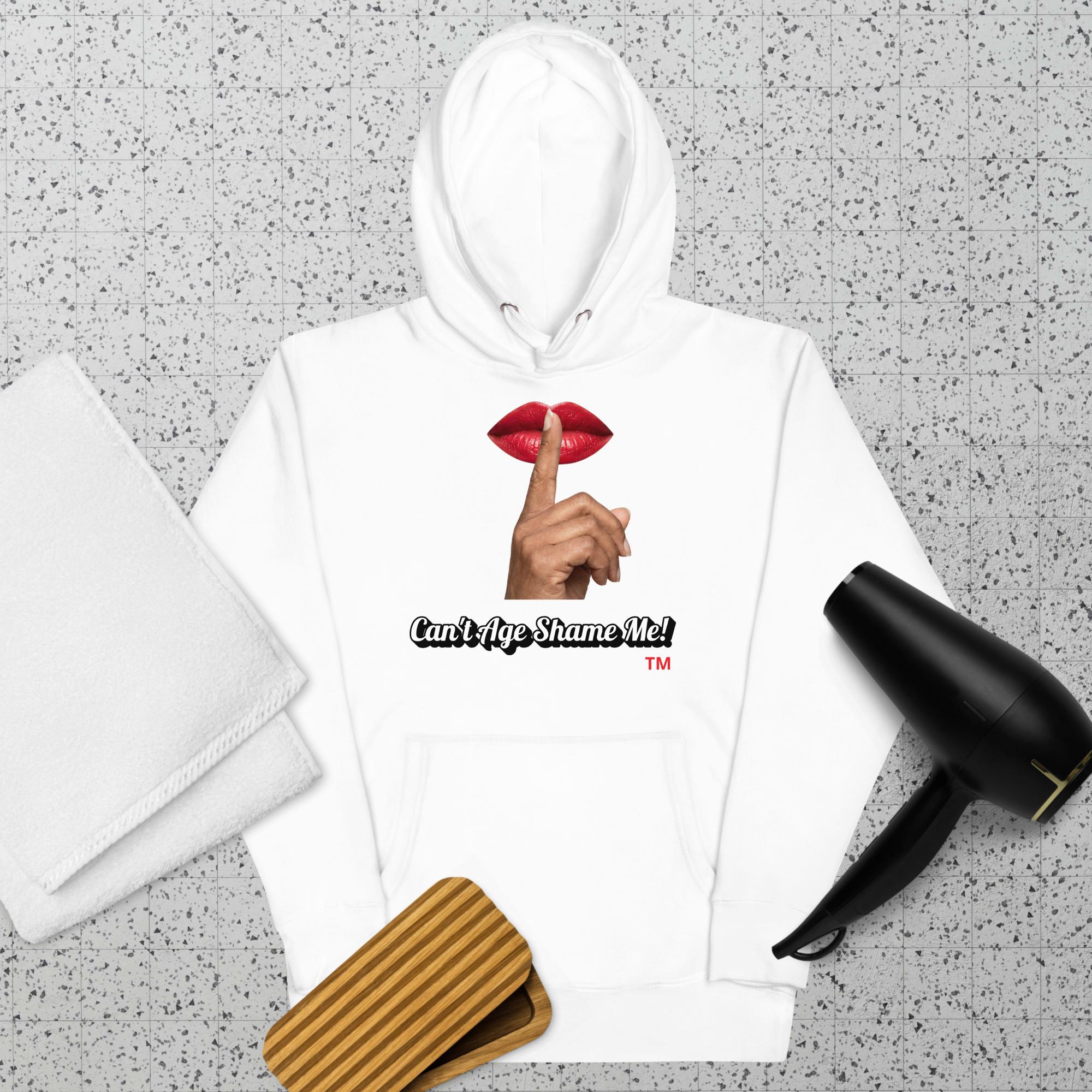 White hoodie with a graphic design of lips and a finger on a textured surface