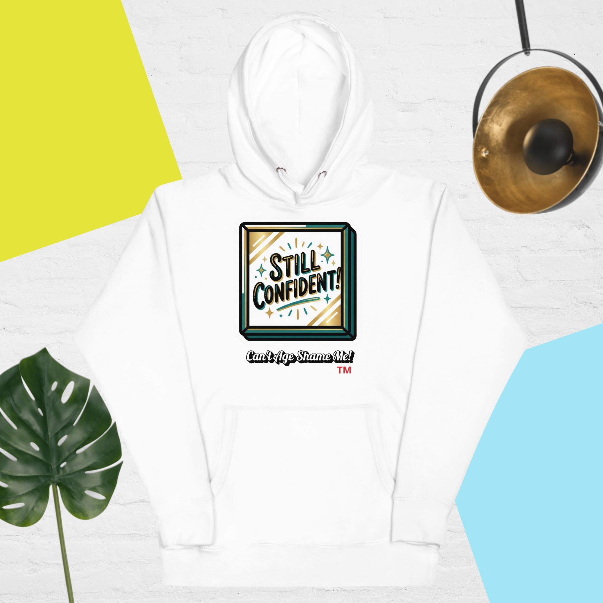 White hoodie with 'Still Confident' graphic on a colorful background