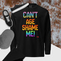 Black long-sleeve shirt with colorful text 'CAN'T AGE SHAME ME!' on a textured surface.