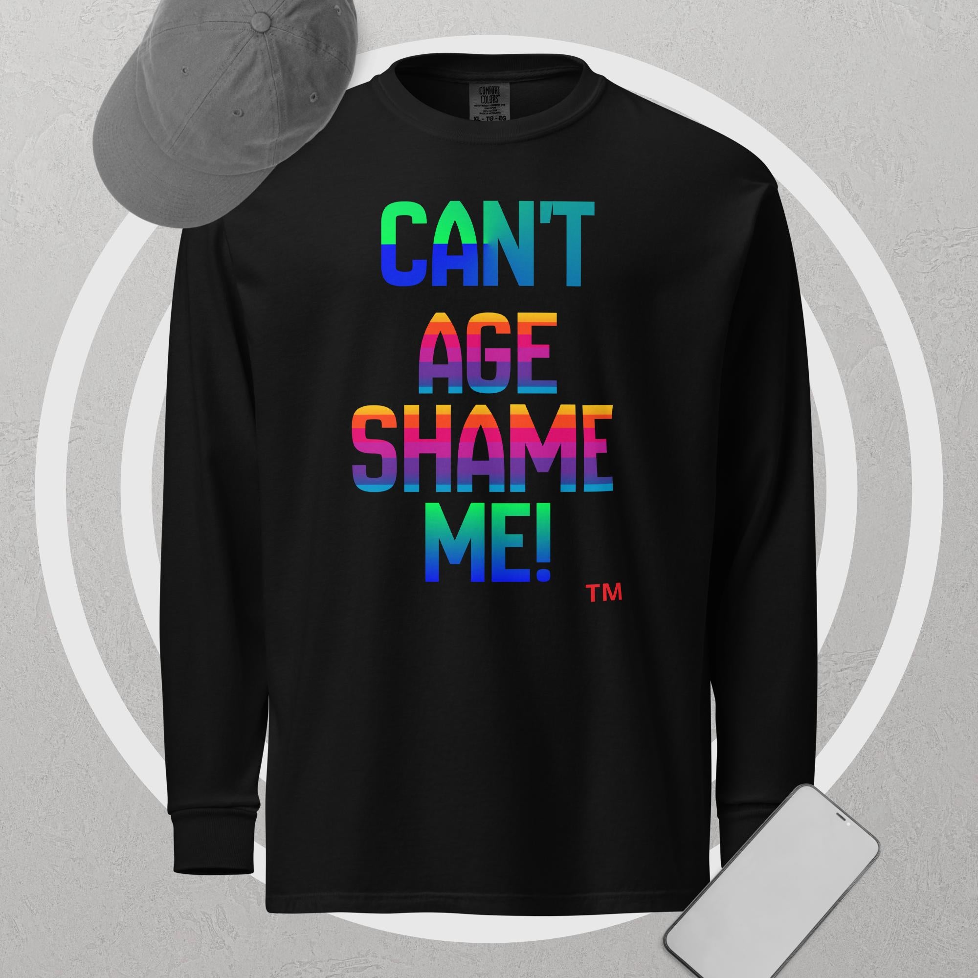 Black long-sleeve shirt with colorful text 'CAN'T AGE SHAME ME!' on a gray background