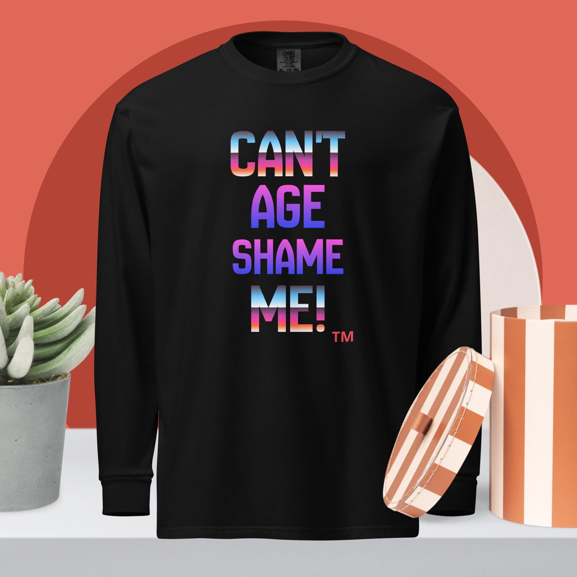 Black long-sleeve shirt with colorful text 'CAN'T AGE SHAME ME!' on a red background