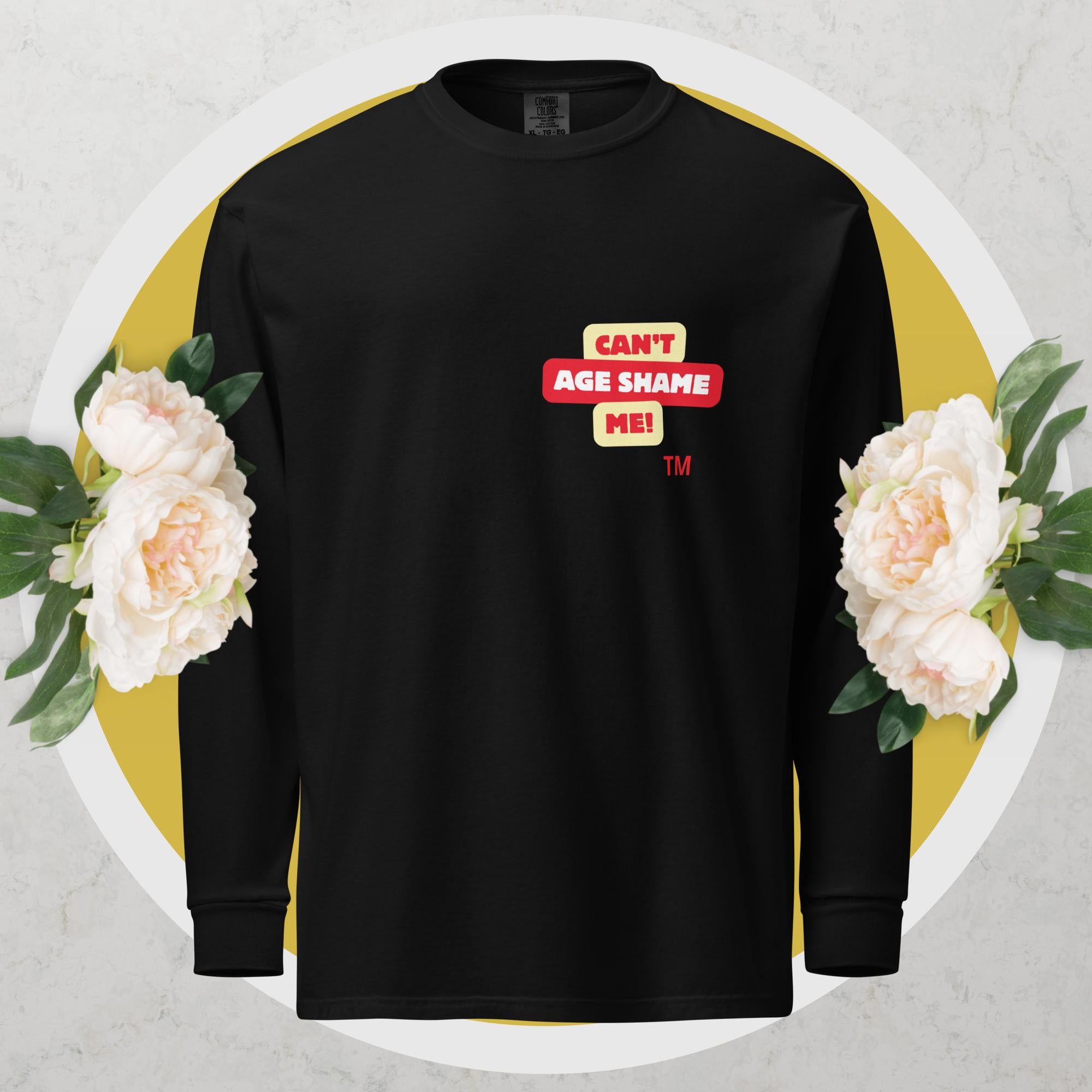 Black long-sleeve shirt with a red and yellow logo text graphic: 'CAN'T AGE SHAME ME!
 on a floral background

