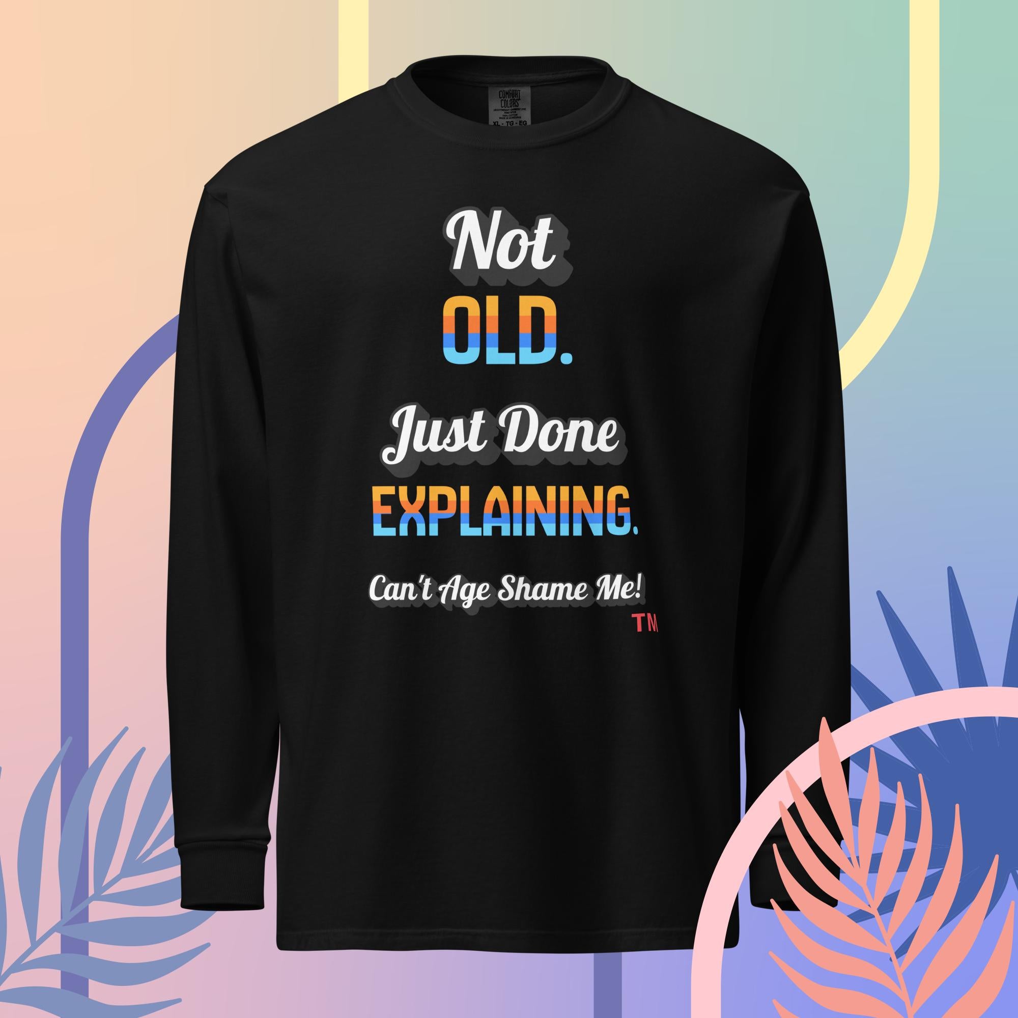 Black long-sleeve shirt with colorful text on a multicolored abstract background