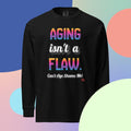 Black long sleeve shirt with 'Aging isn't a flaw' text, paired with jeans and sneakers on 
a multicolored background


