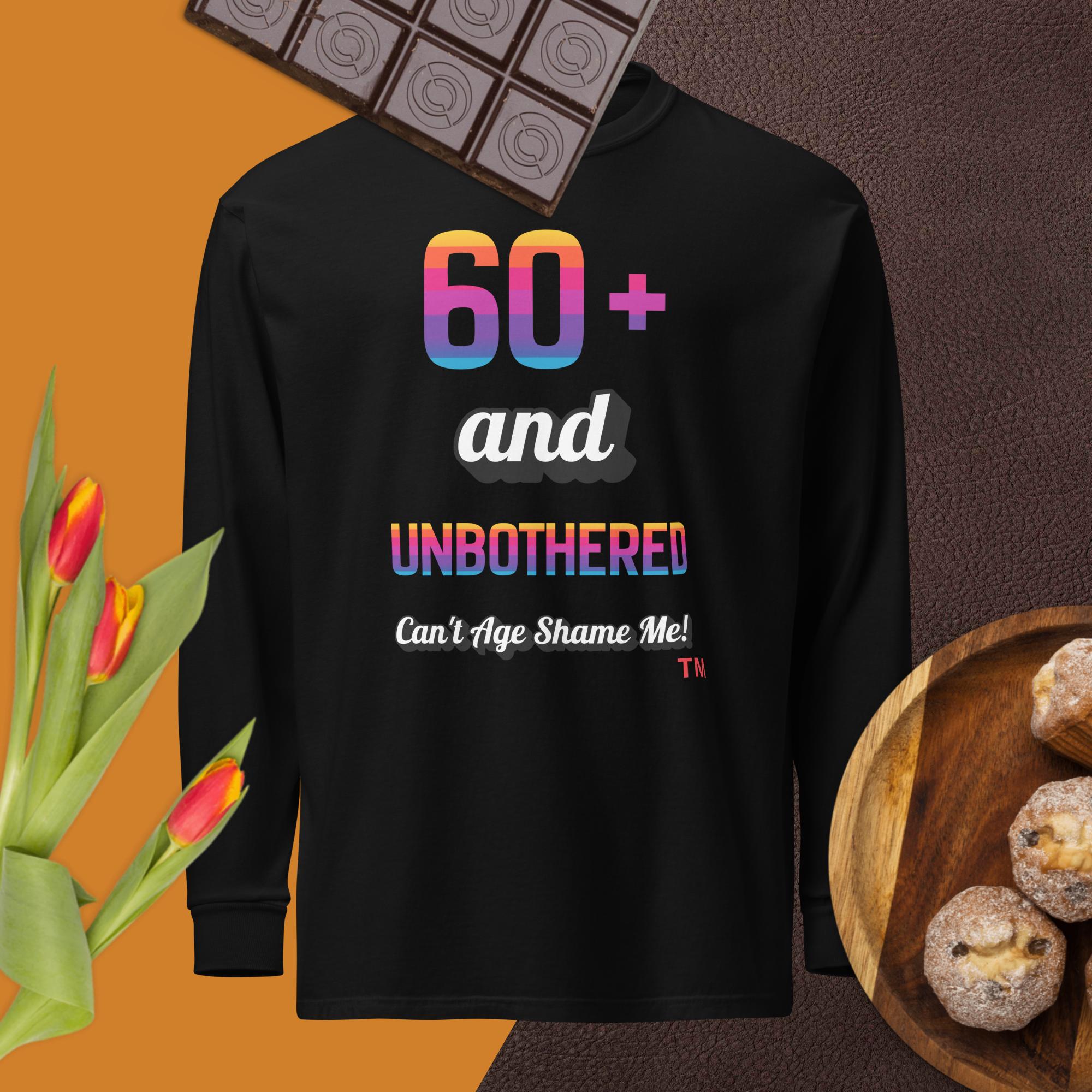 Black sweatshirt with colorful text on a brown background with chocolate, tulips, and cookies.
