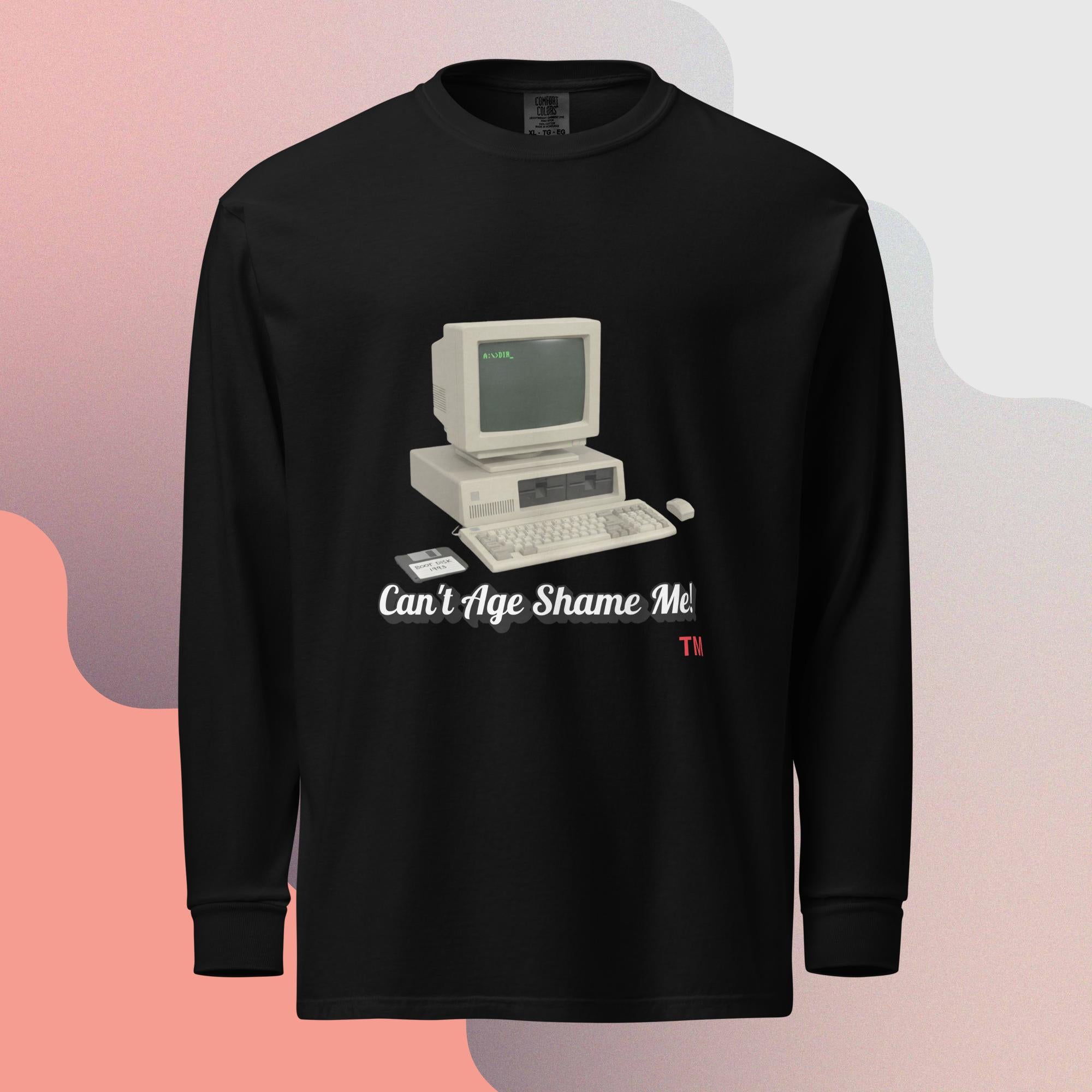 Black long-sleeve shirt with a vintage computer graphic and text  can't age shame me on a gradient background