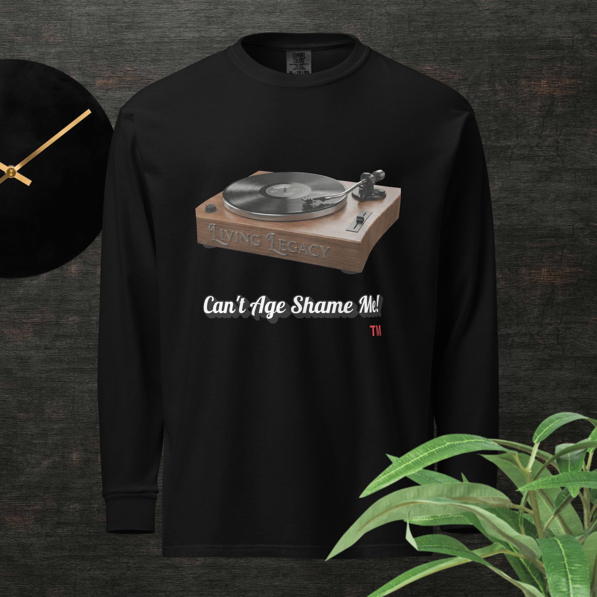 black long-sleeve shirt with a graphic of a turntable and text can't age shame me! on a dark background