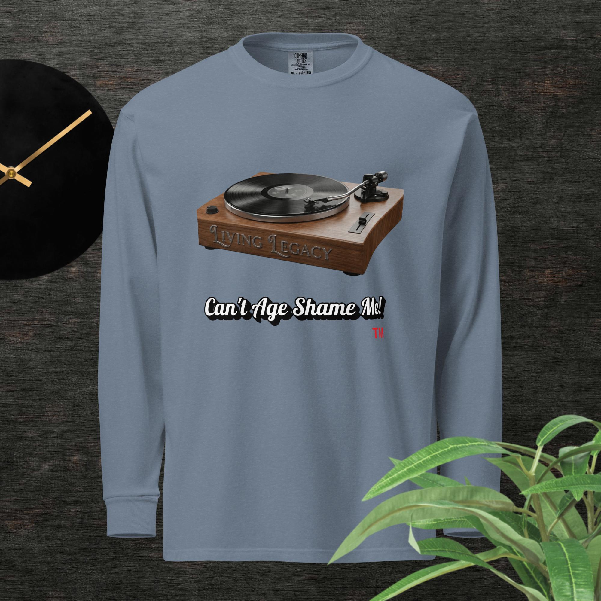 blue long-sleeve shirt with a graphic of a turntable and text can't age shame me! on a dark background