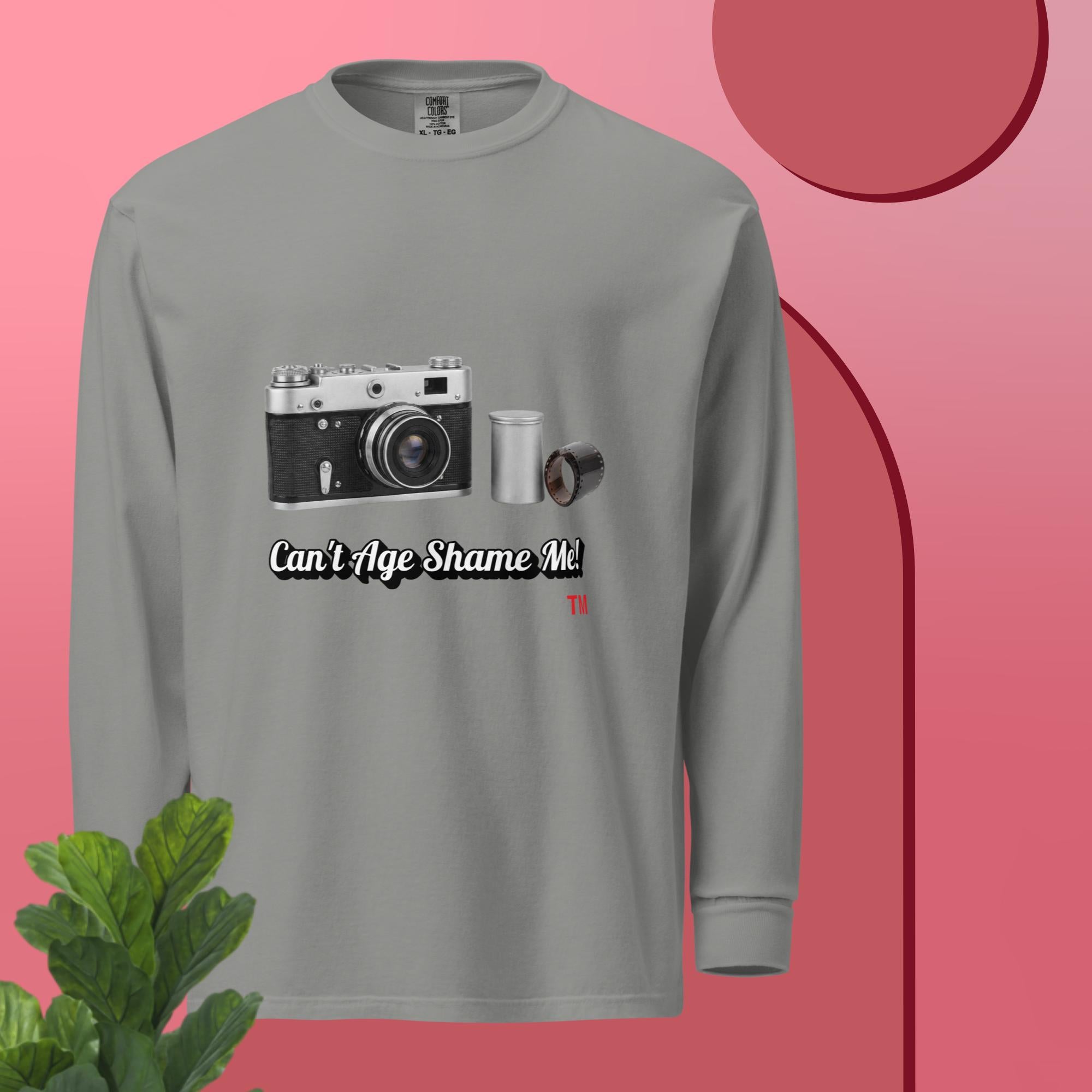 Gray long-sleeve shirt with camera graphic and text 'Can't Age Shame Me' on a pink background