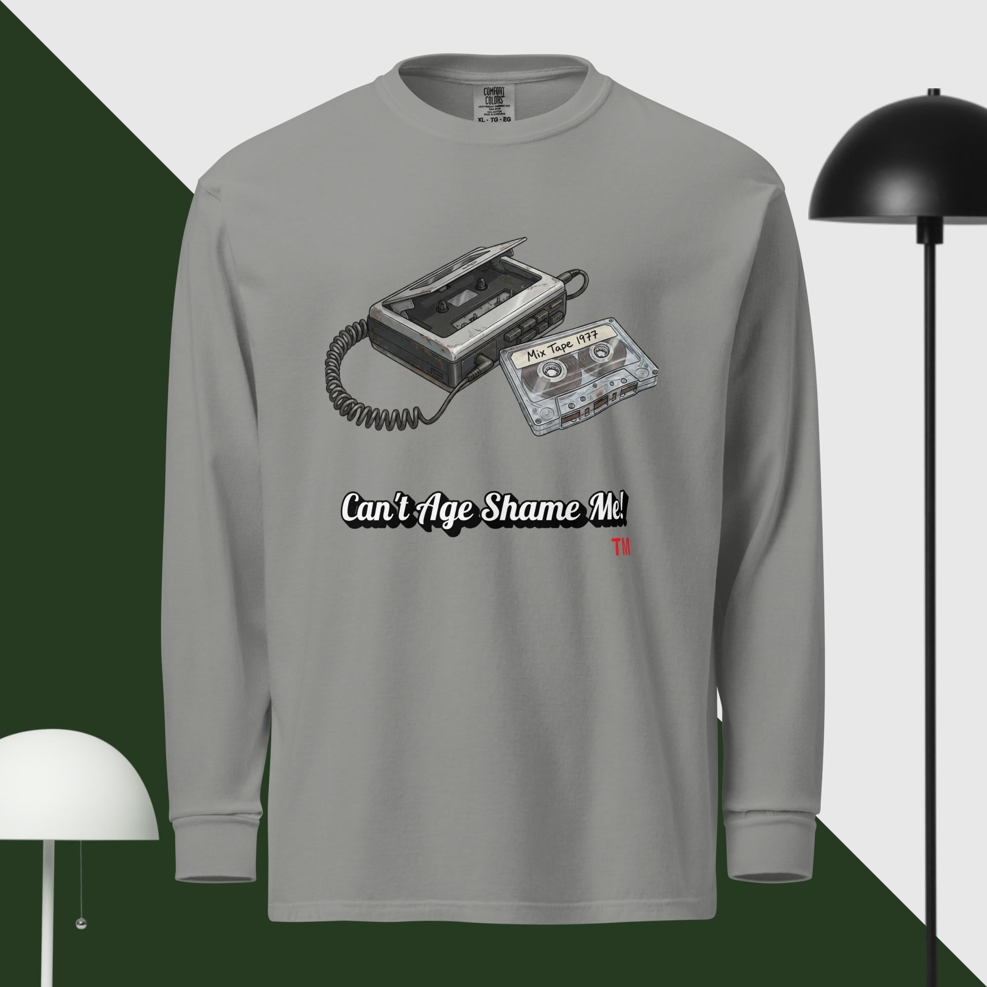 Gray long-sleeve shirt with cassette tape design and text 'Can't Age Shame Me' on a green and white background.
