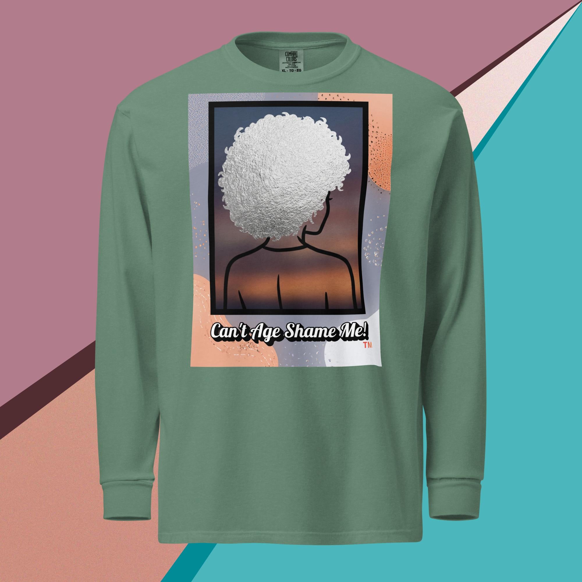 Green long-sleeve shirt with a graphic design of a person with textured hair and text 'Can't Age Shame Me!' on a colorful background.