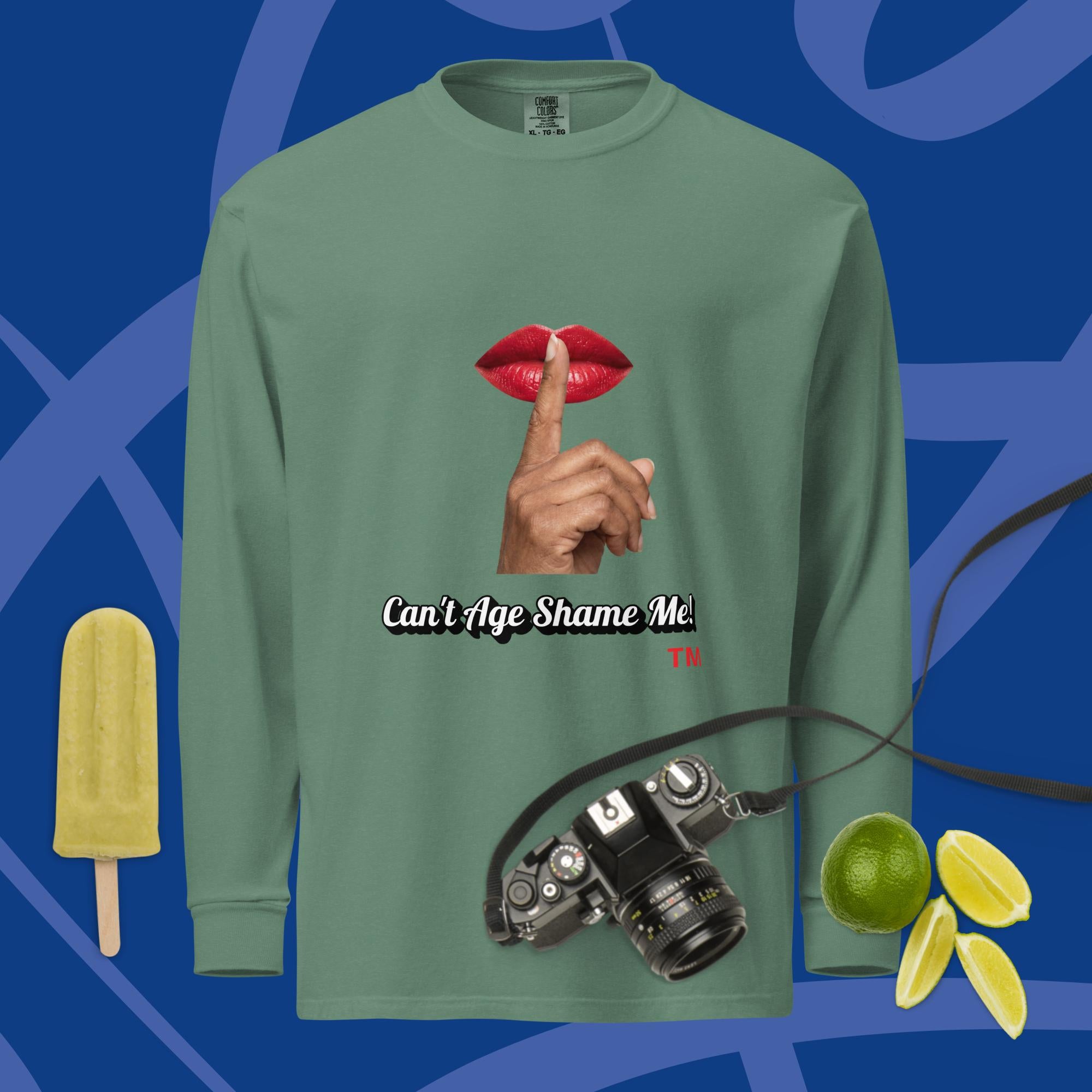 Green long-sleeve shirt with a graphic design of lips and a finger on a blue background