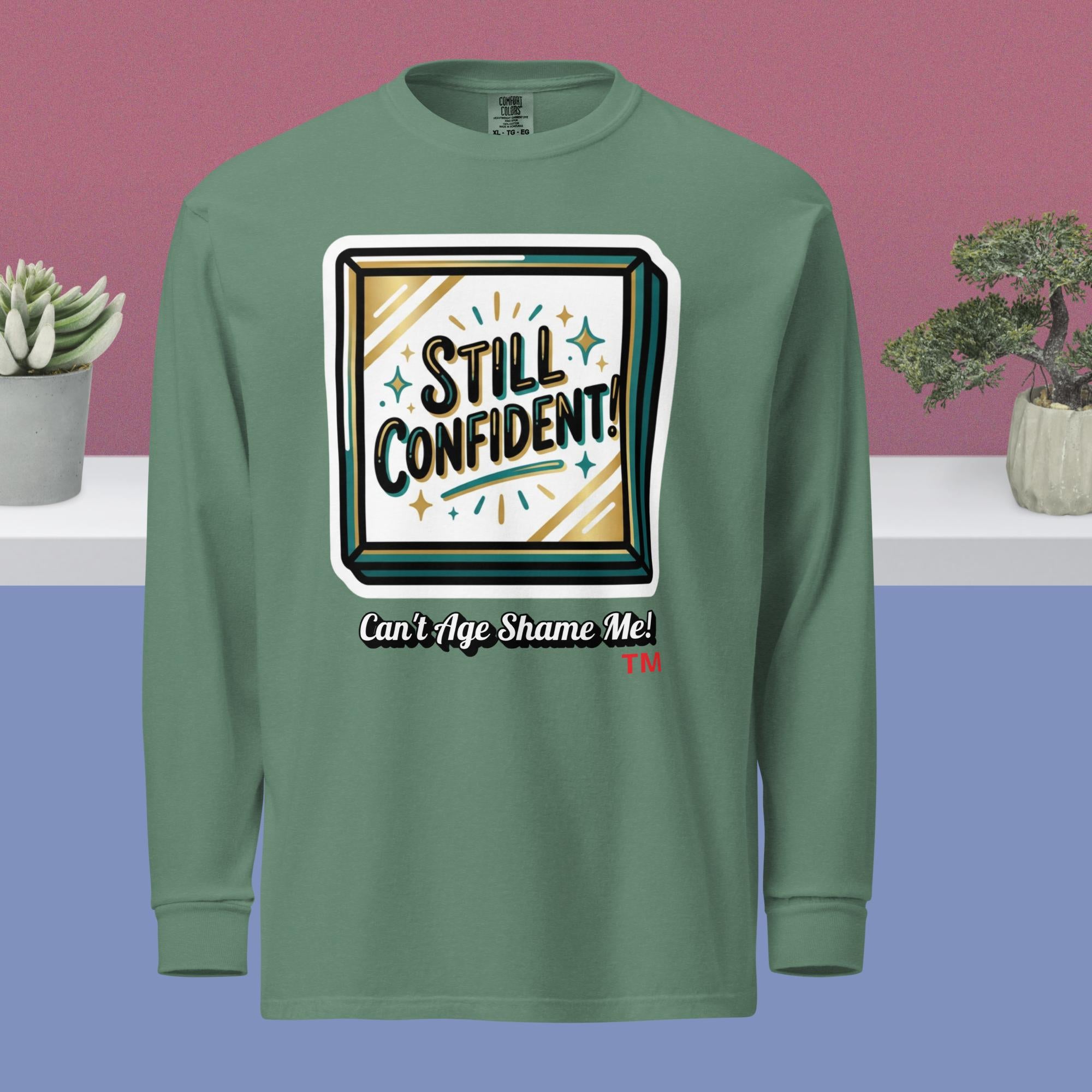 Light Green long-sleeve shirt with 'Still Confident! Can't Age Shame Me!' graphic on a multicolored background