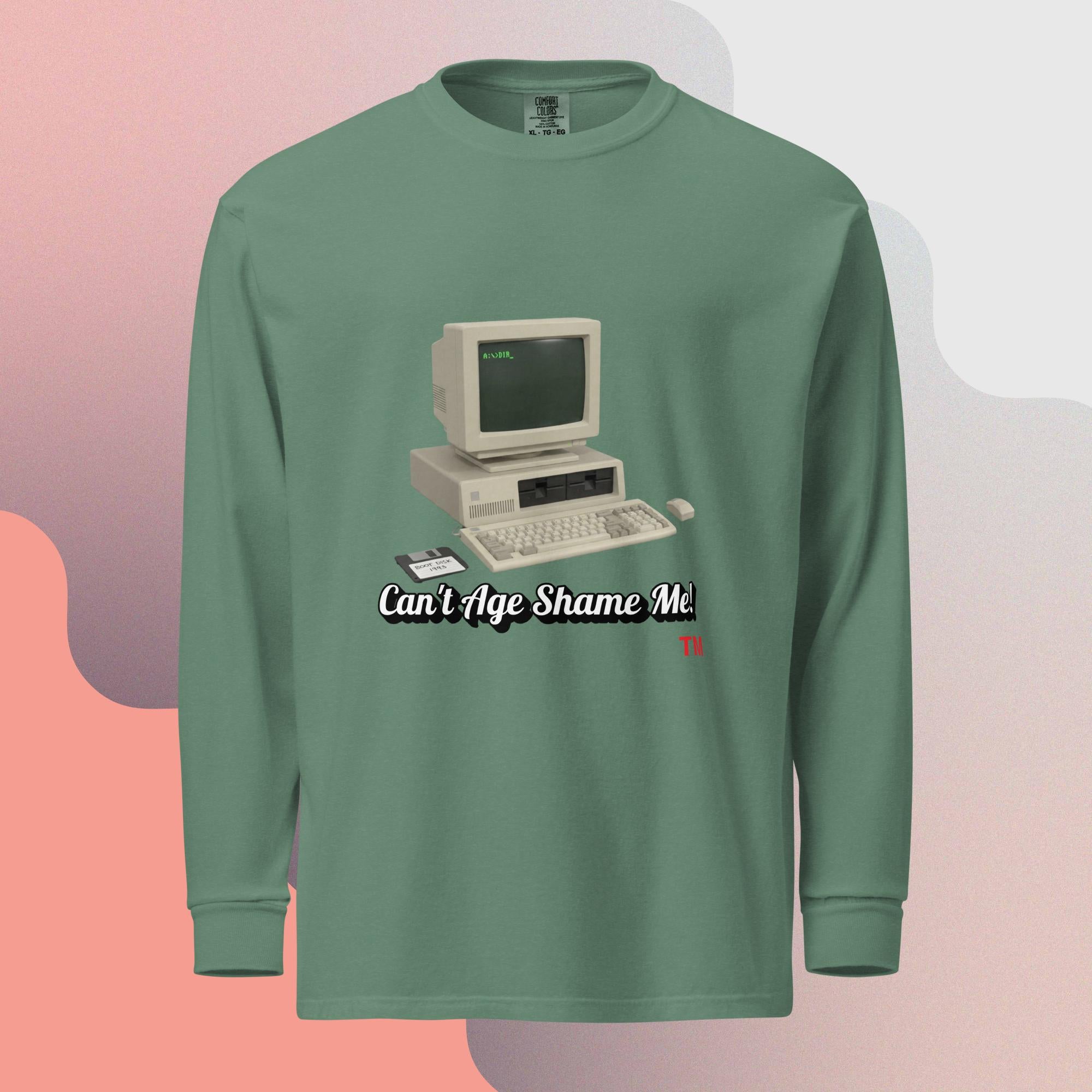 green long-sleeve shirt with a vintage computer graphic and text  can't age shame me on a gradient background