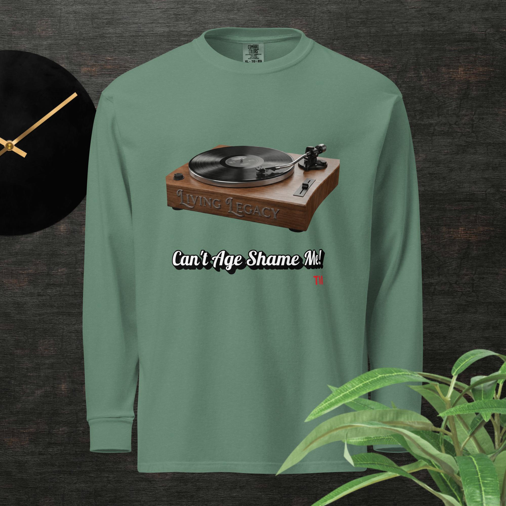 Green long-sleeve shirt with a graphic of a turntable and text can't age shame me! on a dark background