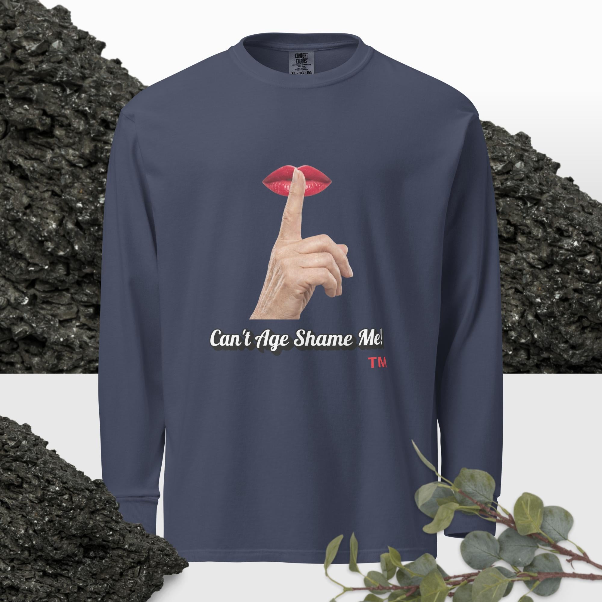 Navy long-sleeve shirt with graphic design of finger on mouth and text 'Can't Age Shame Me' on a textured background.