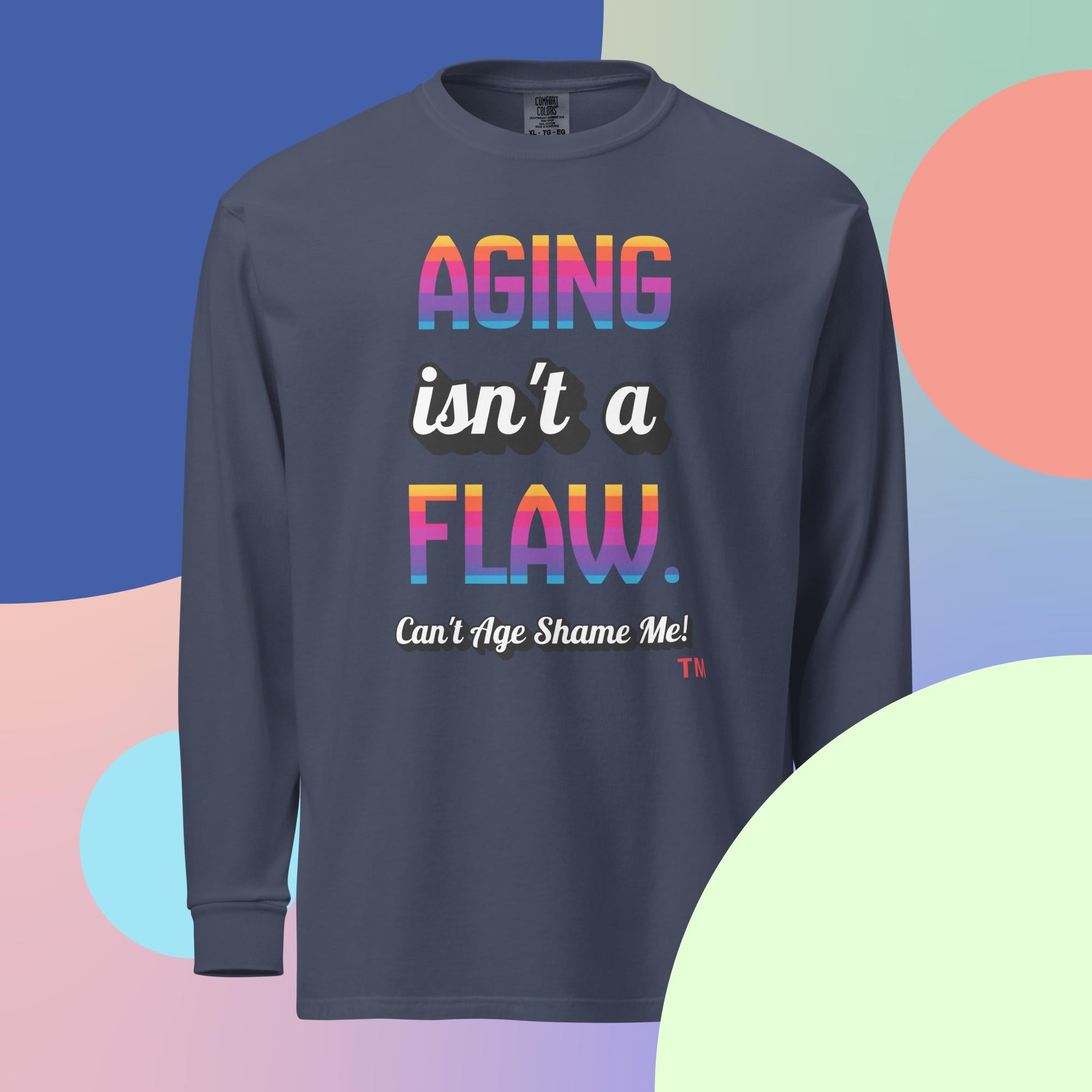 Navy long sleeve shirt with 'Aging isn't a flaw' text, paired with jeans and sneakers on 
a multicolored background

