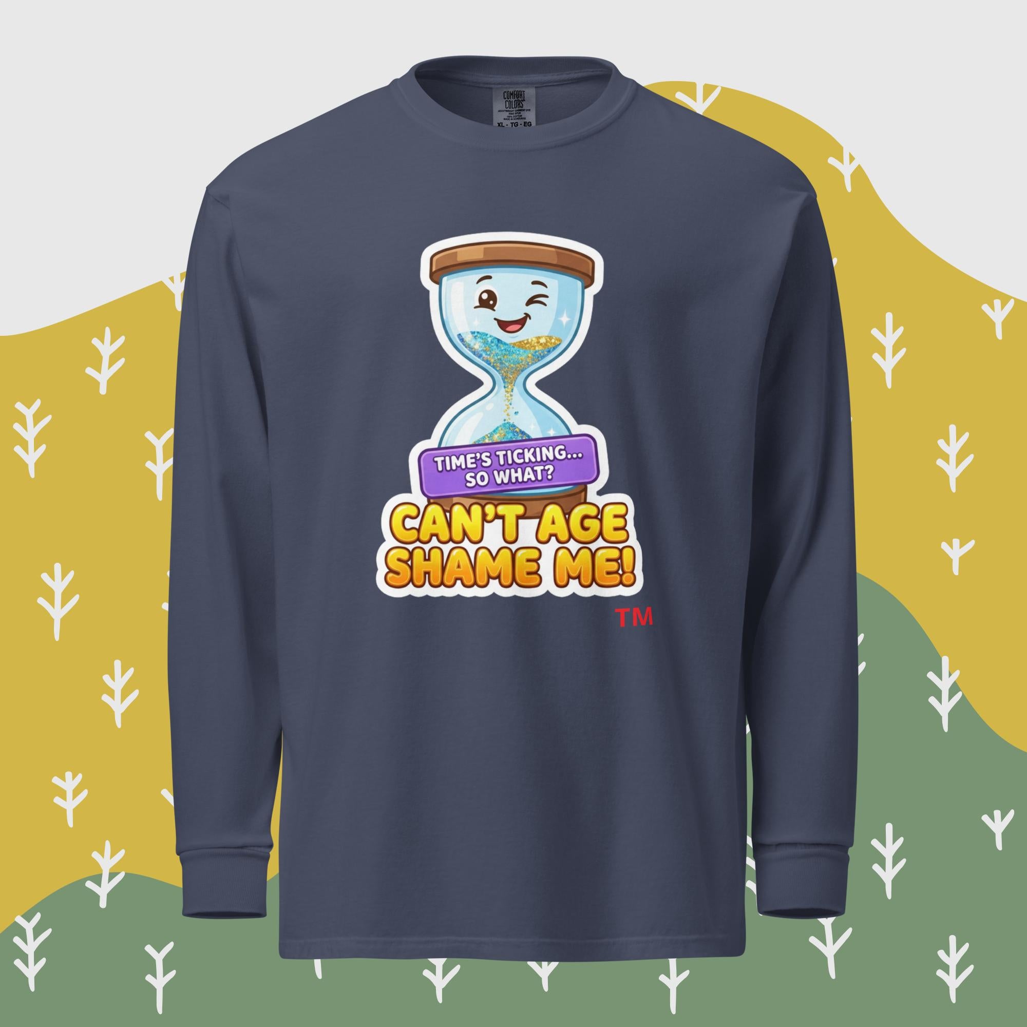 Navy long-sleeve shirt with a cartoon hourglass design and text 'Can't Age Shame Me' graphic on a patterned background

