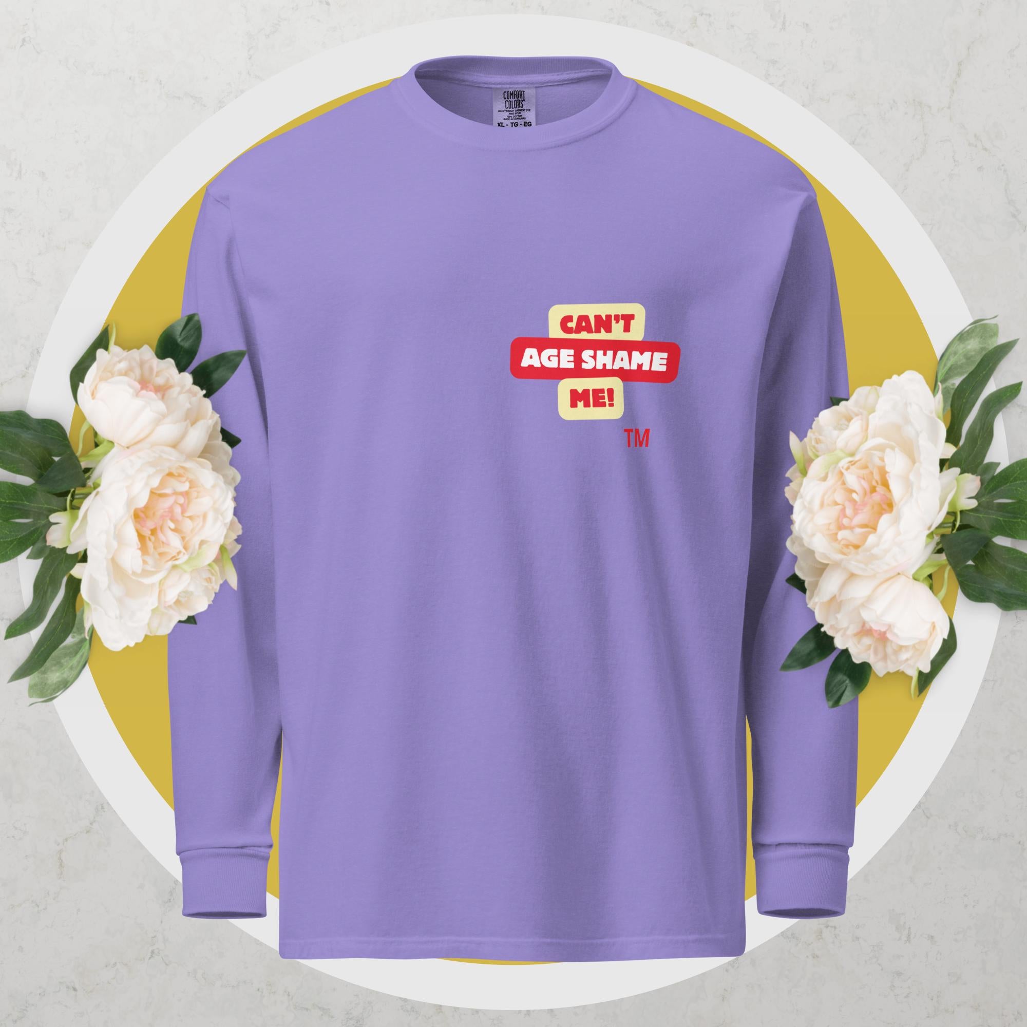 Violet long-sleeve shirt with a red and yellow logo text graphic: 'CAN'T AGE SHAME ME!
 on a floral background

