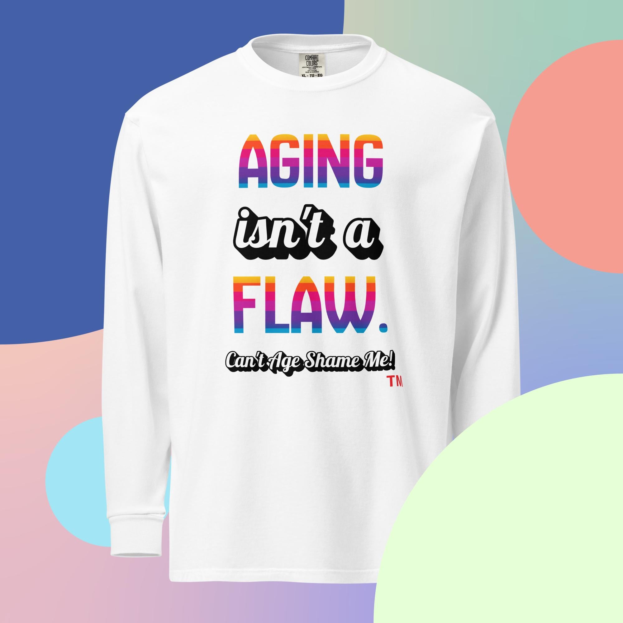 White long sleeve shirt with 'Aging isn't a flaw' text, paired with jeans and sneakers on 
a multicolored background

