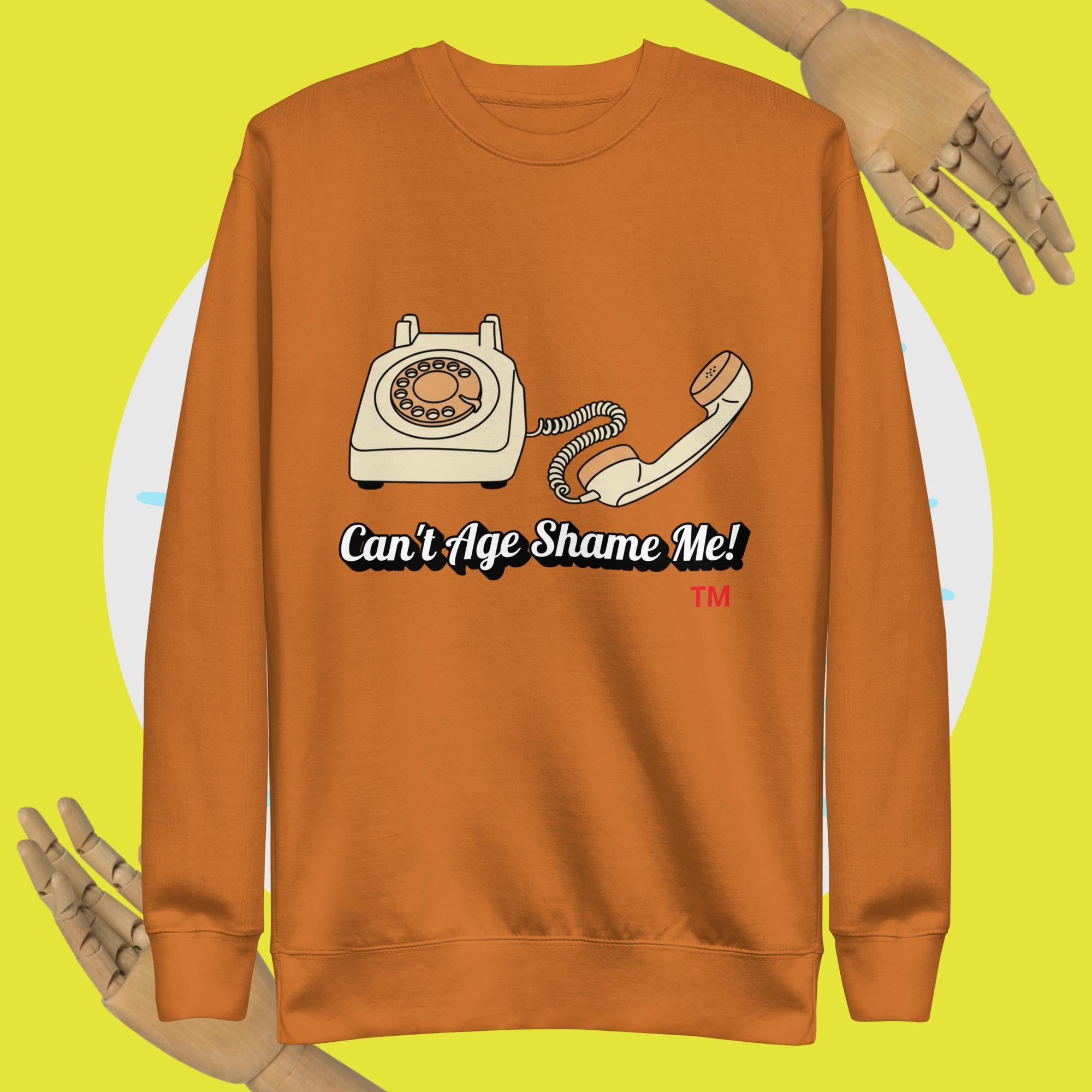 adobe sweatshirt with vintage phone graphic and 'Can't Age Shame Me!' text on a yellow background